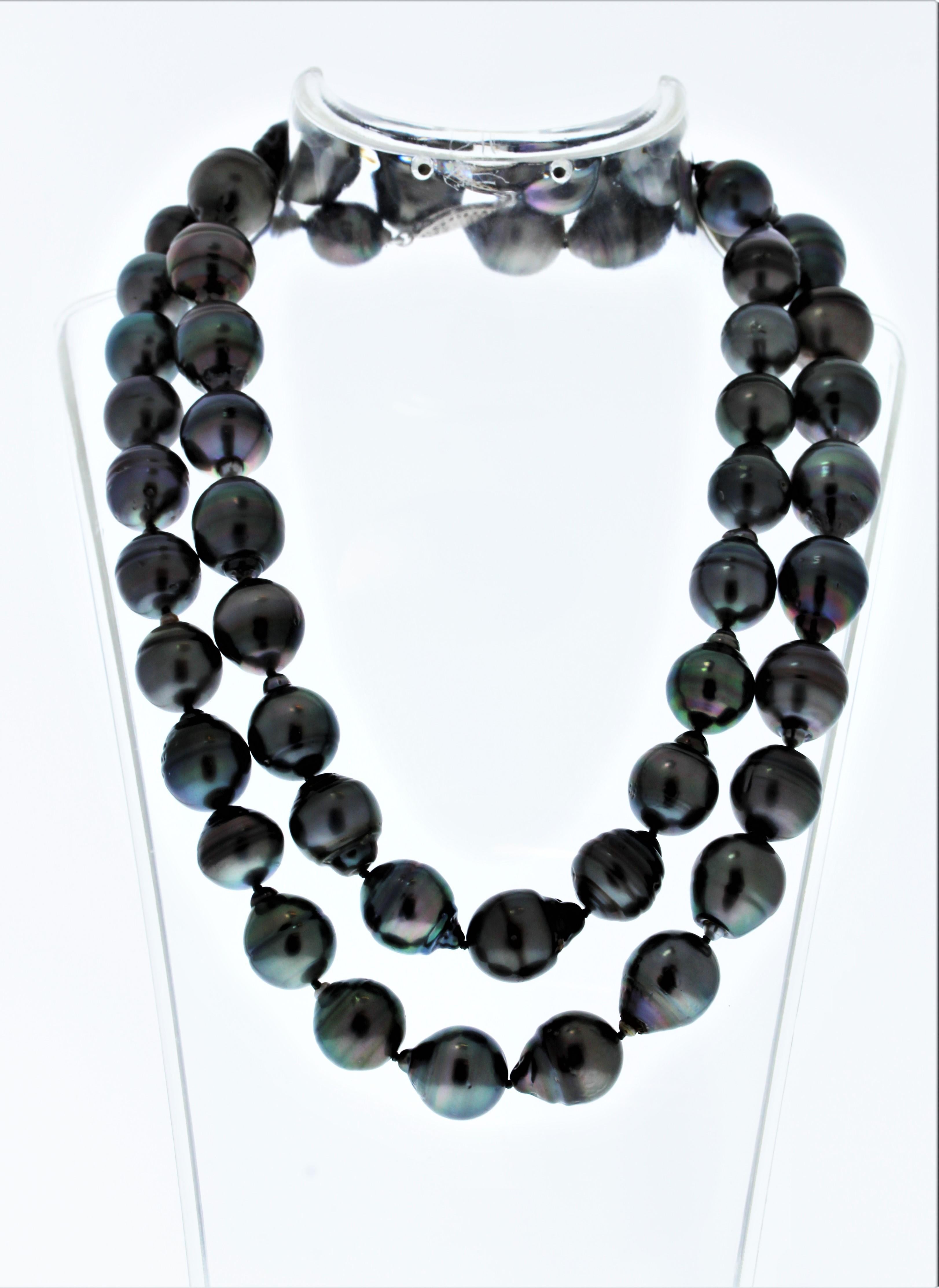 Exceptionally elegant and ravishingly gorgeous. This lavish Tahitian black pearl and diamond necklace delivers on style and sophistication. It fastens securely with an attractive and substantial clasp. Crafted of striking 14 Karat white gold, this