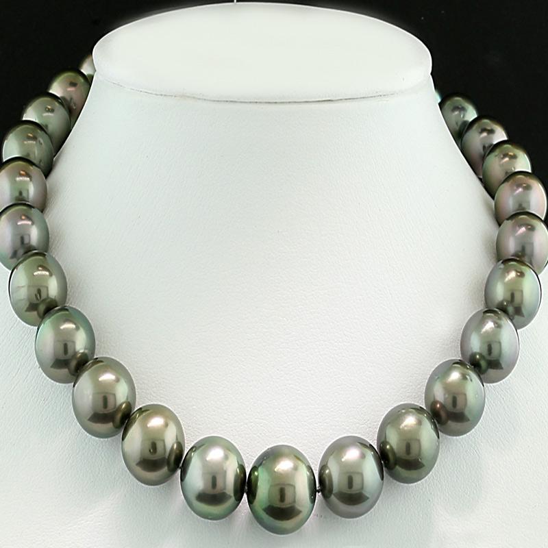A beautiful necklace with 35 Tahitian cultured pearls, arranged in a consistent progression from around 11.1 to 13.7 mm. These pearls display a sophisticated silver-gray hue with gentle shimmering overtones in rose, subtle green-blue, and silver,