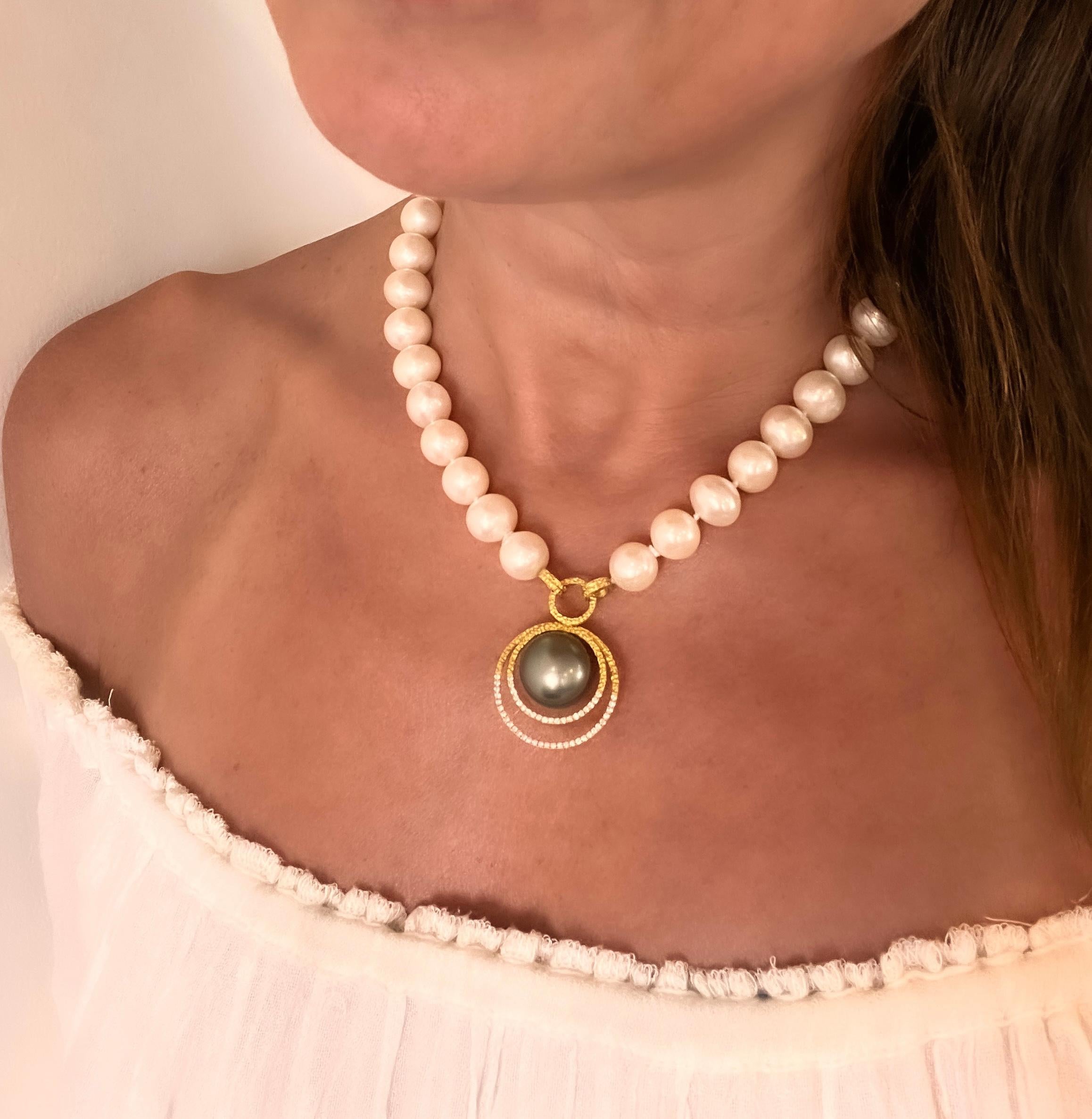 This gorgeous strand of pearls has a modern twist and features a fabulous center Tahitian pearl set in double 22k gold. Finished with beautifully set accented diamonds! Handmade, hand textured and one of a kind! The Pearl Collection represents the