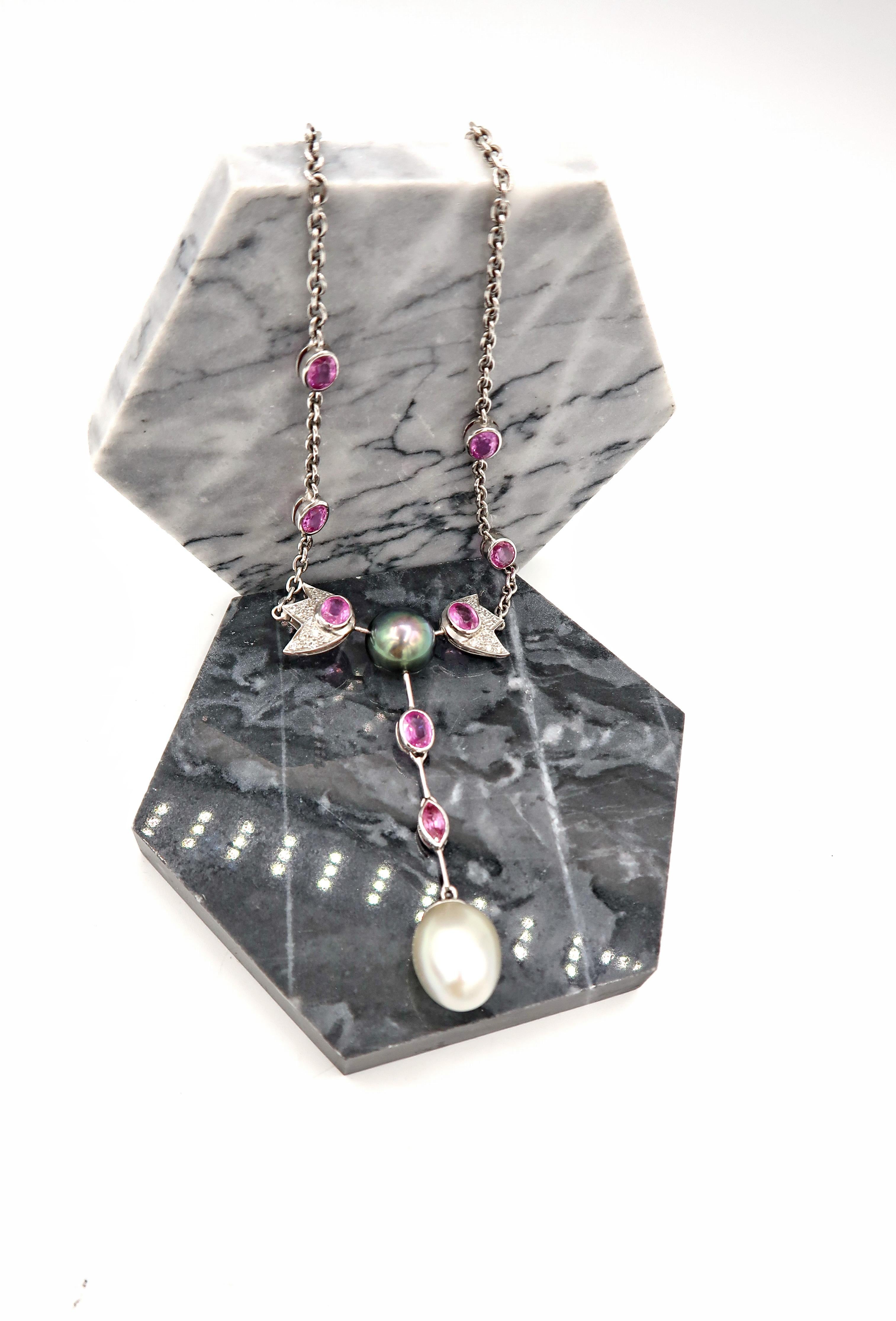 Tahitian Pearl, Pink Sapphire, and Diamond Pavé Chain Necklace with White South Sea Pearl Drop

Gold: 18K 29.89g.
Diamond: 1.20ct.
Pink Sapphire: 10.75cts.
Tahitian Pearl: 11.5 mm x 11.5 mm
White South Sea Pearl: 13.5mm x 16.5mm