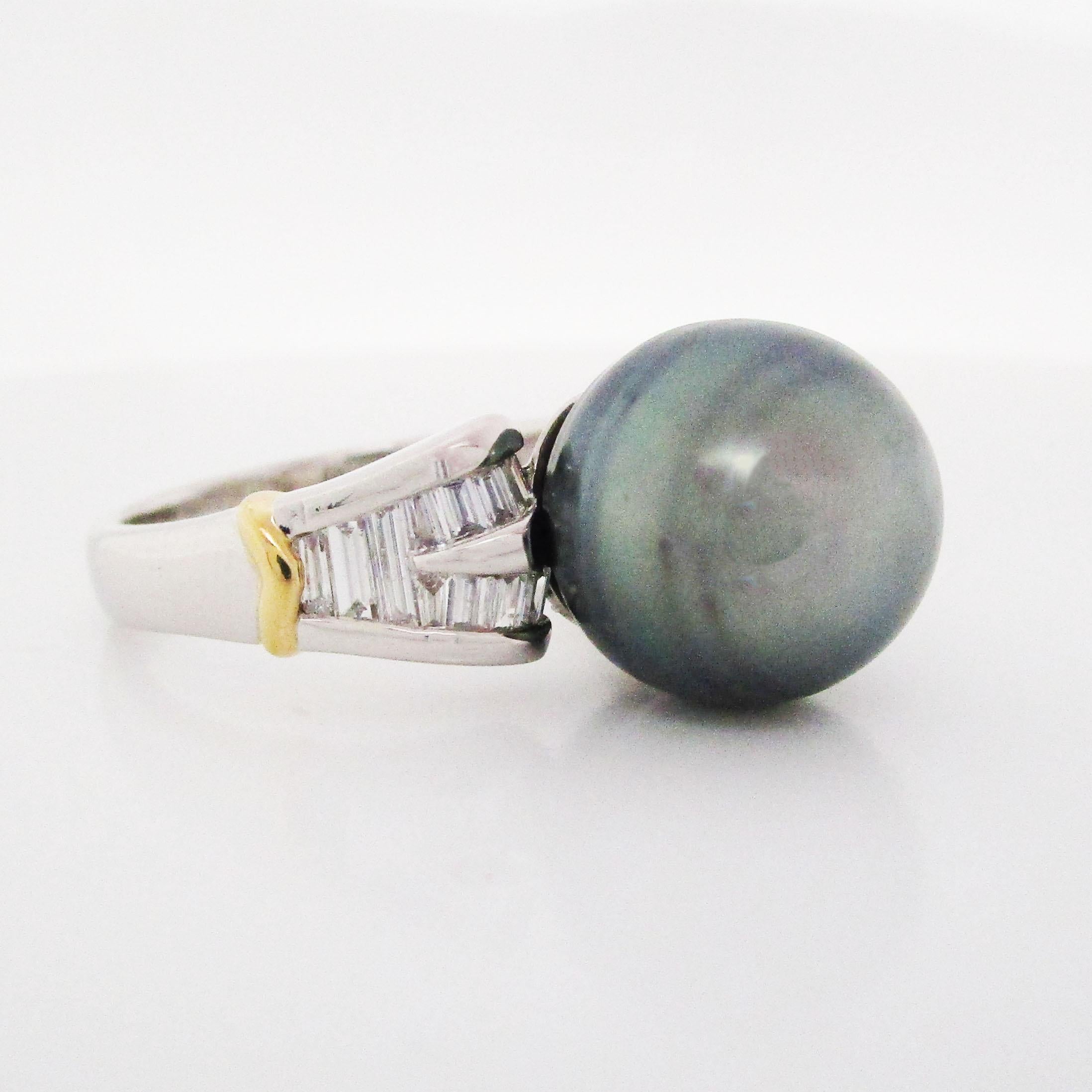 This platinum ring boasts a stunning array of white baguette diamonds framing an absolutely jaw-dropping 12mm Tahitian pearl center! The shoulders of the ring have a yellow gold accent that provides the perfect complement for the brilliant white