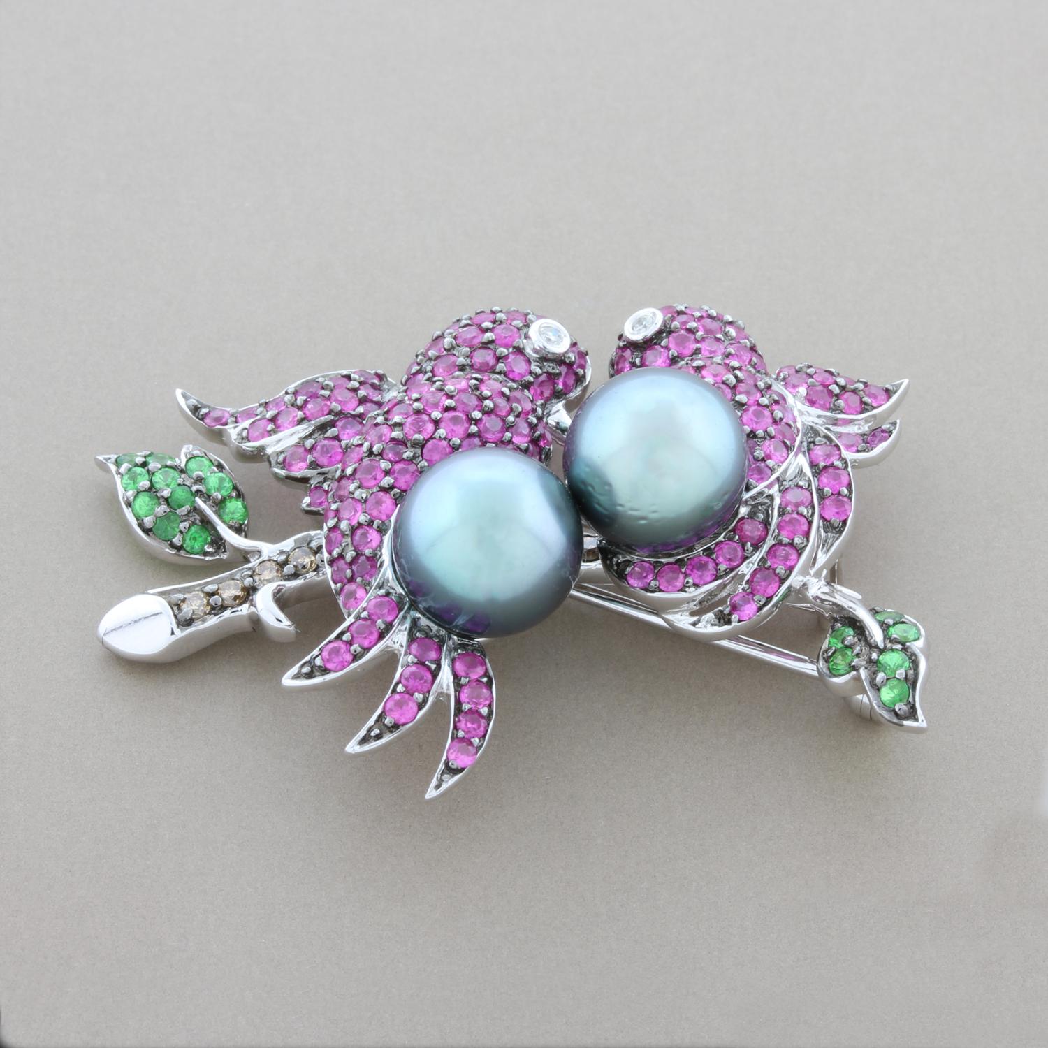 These two ruby studded love birds resting a branch of fancy color diamonds with emerald leaves and a pair of perfectly rounded lustrous Tahitian pearls will melt your heart. Set in 14K white gold and ready to be worn.

Brooch Length: 1.75