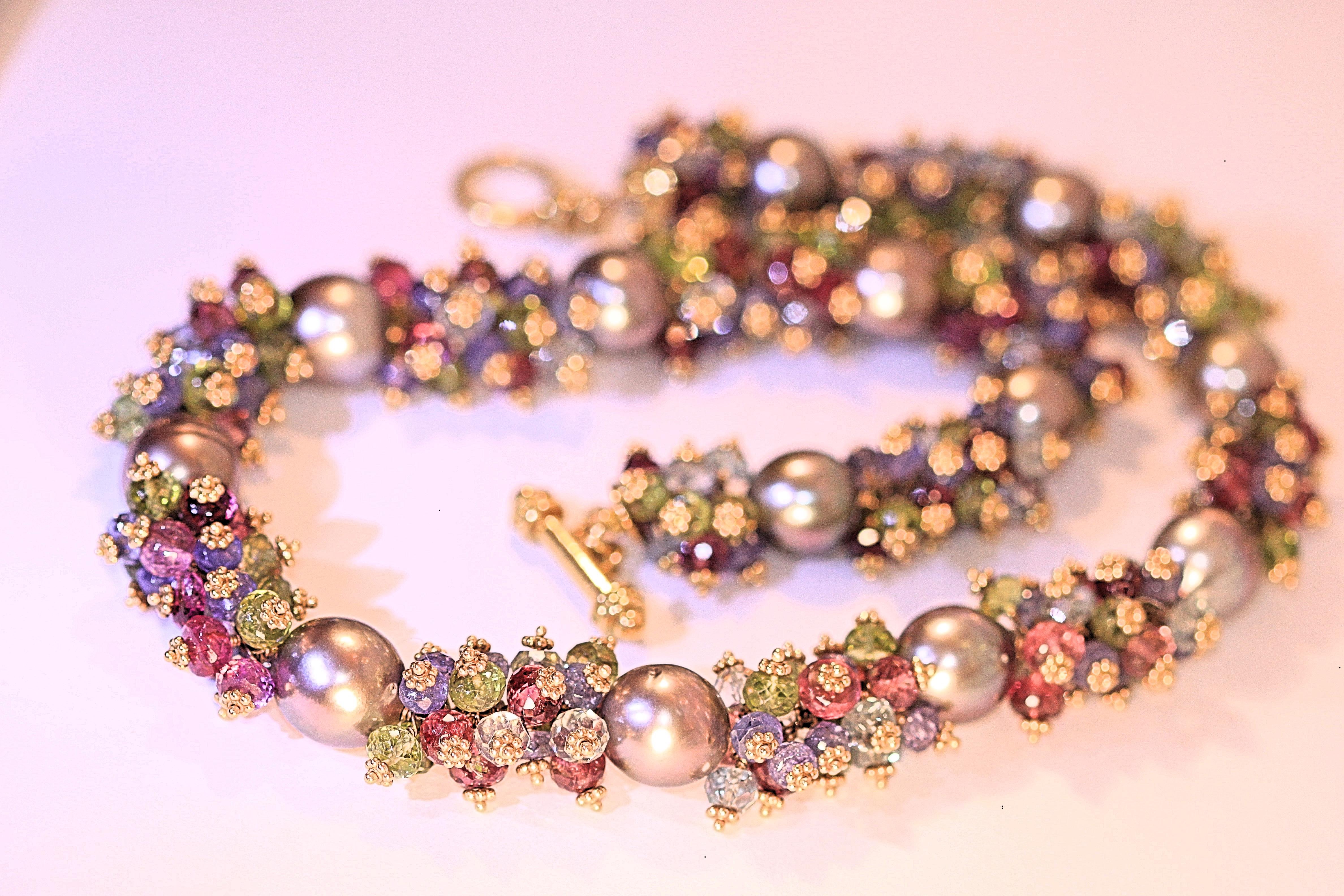 A multi-colored semi precious and Tahitian pearl necklace that was designed by Marya Dabrowski.  The stunning necklace has 14 beautiful Tahitian pearls and clusters of semi precious stones.  The Tahitian pearls are well matched and they measure 11