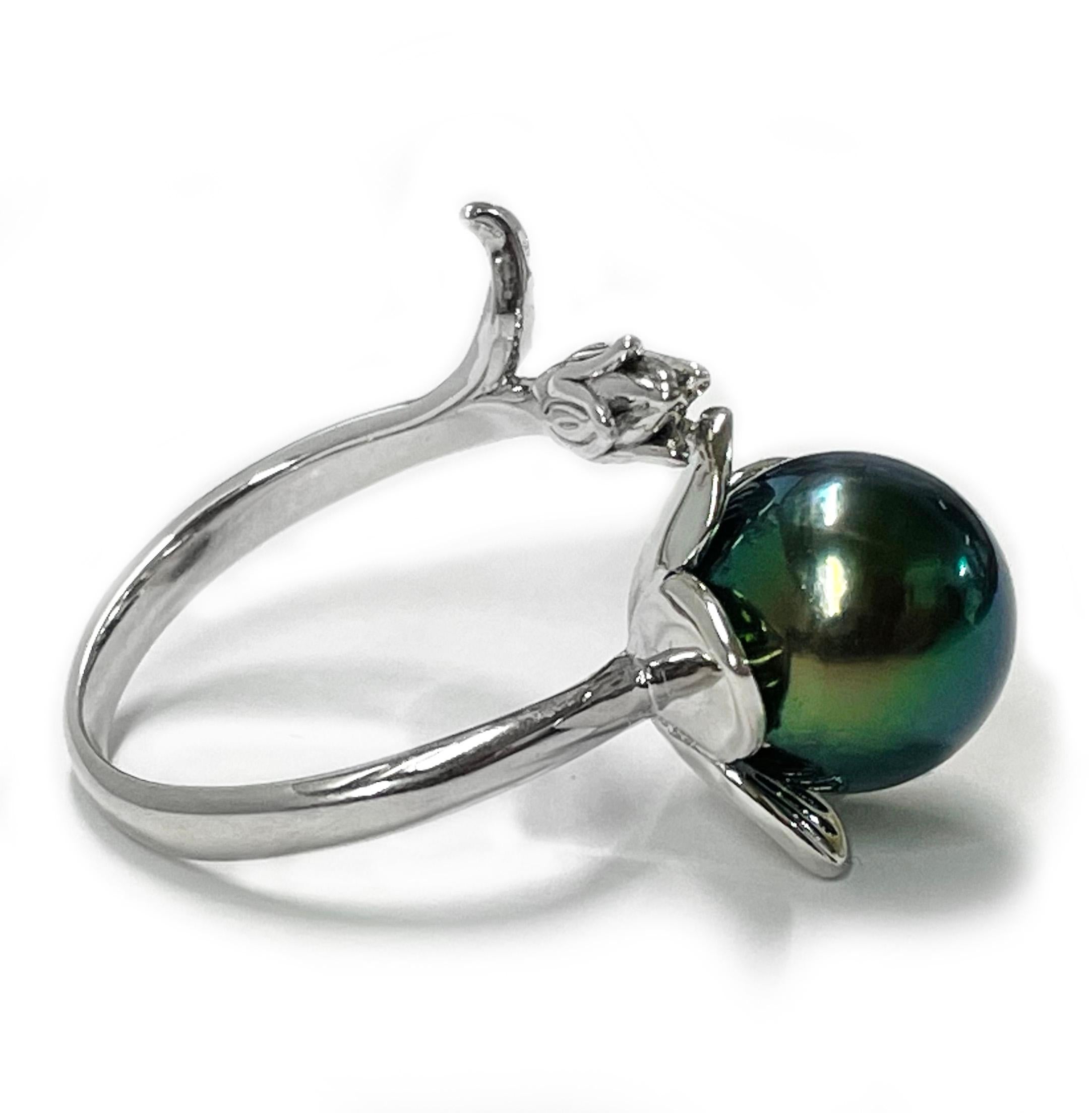 Tahitian Pearl Sterling Silver Ring. The ring features a band that mimics a stem and flower in a bypass design with an absolutely gorgeous green colored Tahitian pearl. The pearl measures 10.5mm and is set on a five petal sterling silver flower. The