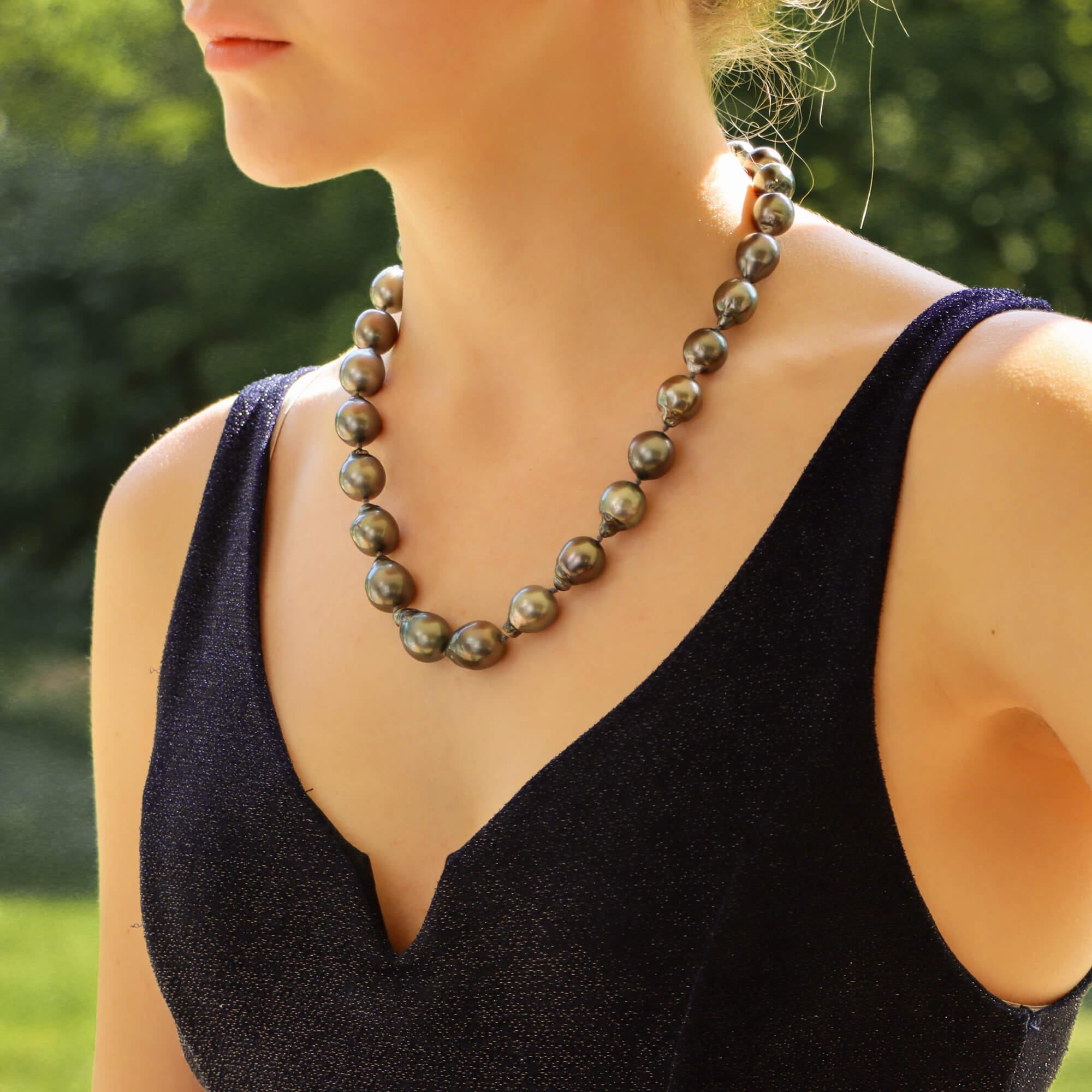 A highly unique Tahitian pearl strand necklace set with a diamond 18k white gold ball clasp.

The strand is composed of 27 individual Tahitian baroque pearls, all varying in size from 14-22 millimetres. The necklace is fastened with an 18k white