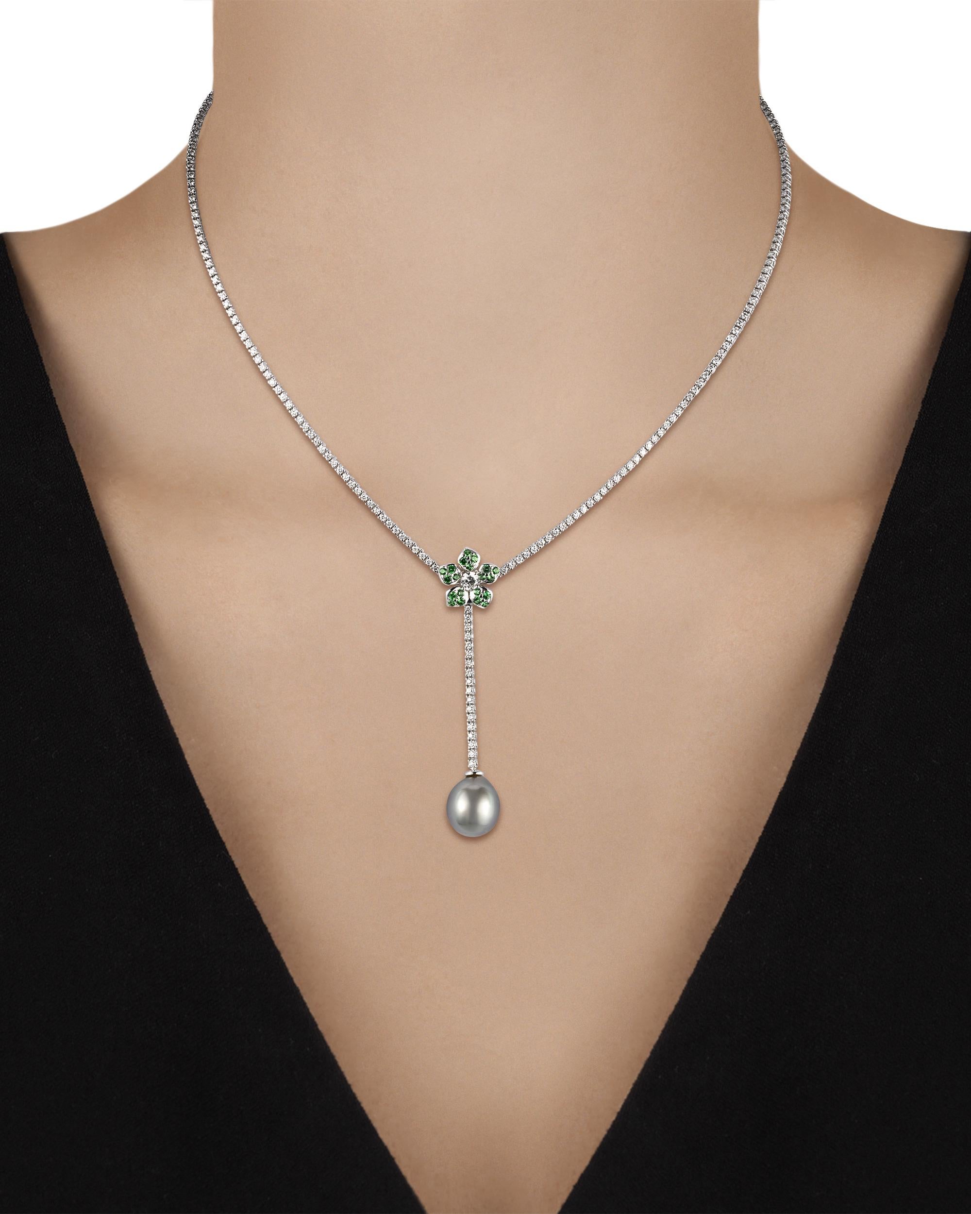 An 11mm Tahitian pearl elegantly drops from a blossom encrusted with 0.43 carat of bright tsavorites in this necklace. White diamonds totaling 2.92 carats offer sparkle throughout the 18K white gold setting.

Necklace: 16