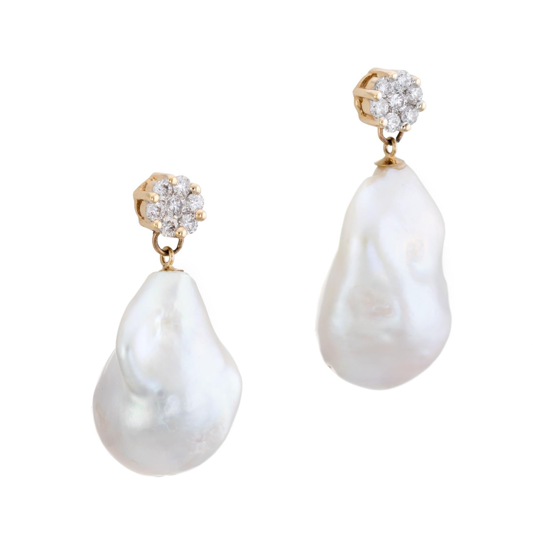 Elegant pair of Tahitian baroque pearl & diamond earrings, crafted in 14k yellow gold. 

Large irregular shaped Tahitian South Sea baroque pearls measure 22mm x 14mm and 20mm x 13.5mm. The pearls exhibit excellent luster with a rose overtone. Round