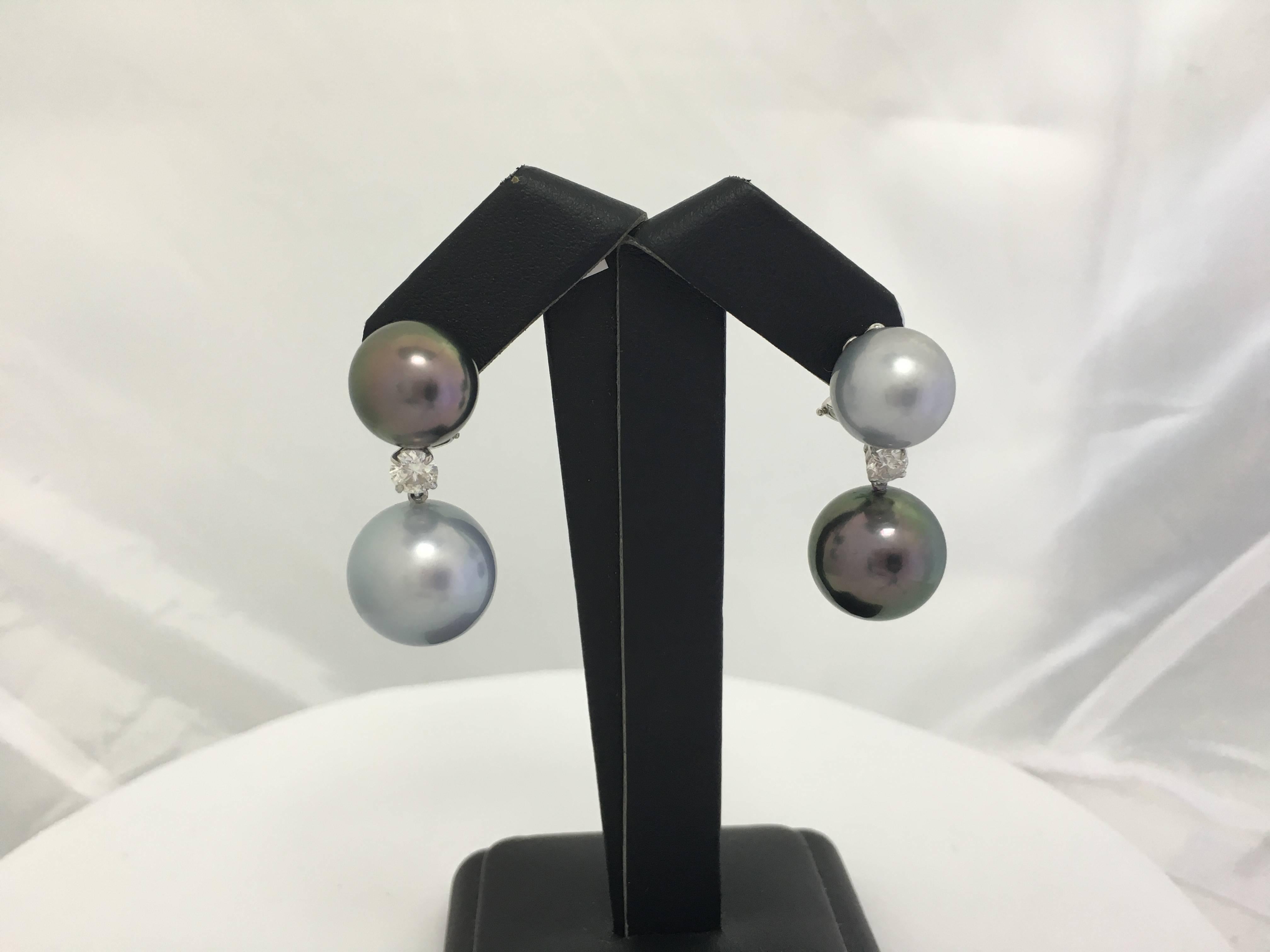 18K White Gold drop earrings featuring four two tone Tahitian pearls measuring 12-14 mm with two round brilliants weighing 0.60 carats. 

Pearl Quality : AA
Pearl luster: AA