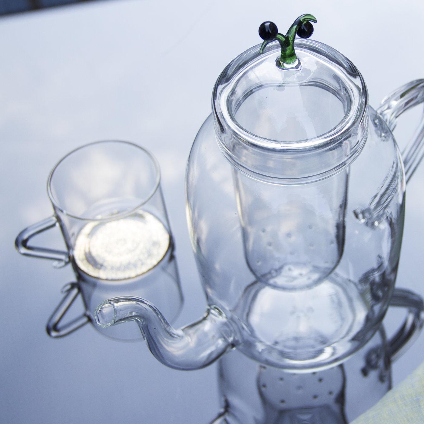 Ethereal and playful, this teapot is entirely handcrafted of transparent mouth-blown glass in a curvaceous silhouette that is elegant and timeless. The piece comprises the main bowl (with spout and handle), the filter (that rests inside the mouth of