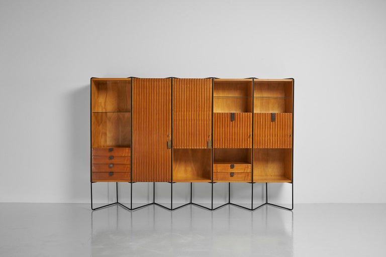 A fantastic, and unique constructed cabinet designed by Japanese designer Taichiro Nakai and manufactured by Permanente Mobili Cantu, Italy 1953. This cabinet is made of maple wood and has a black painted metal structure. This cabinet has the