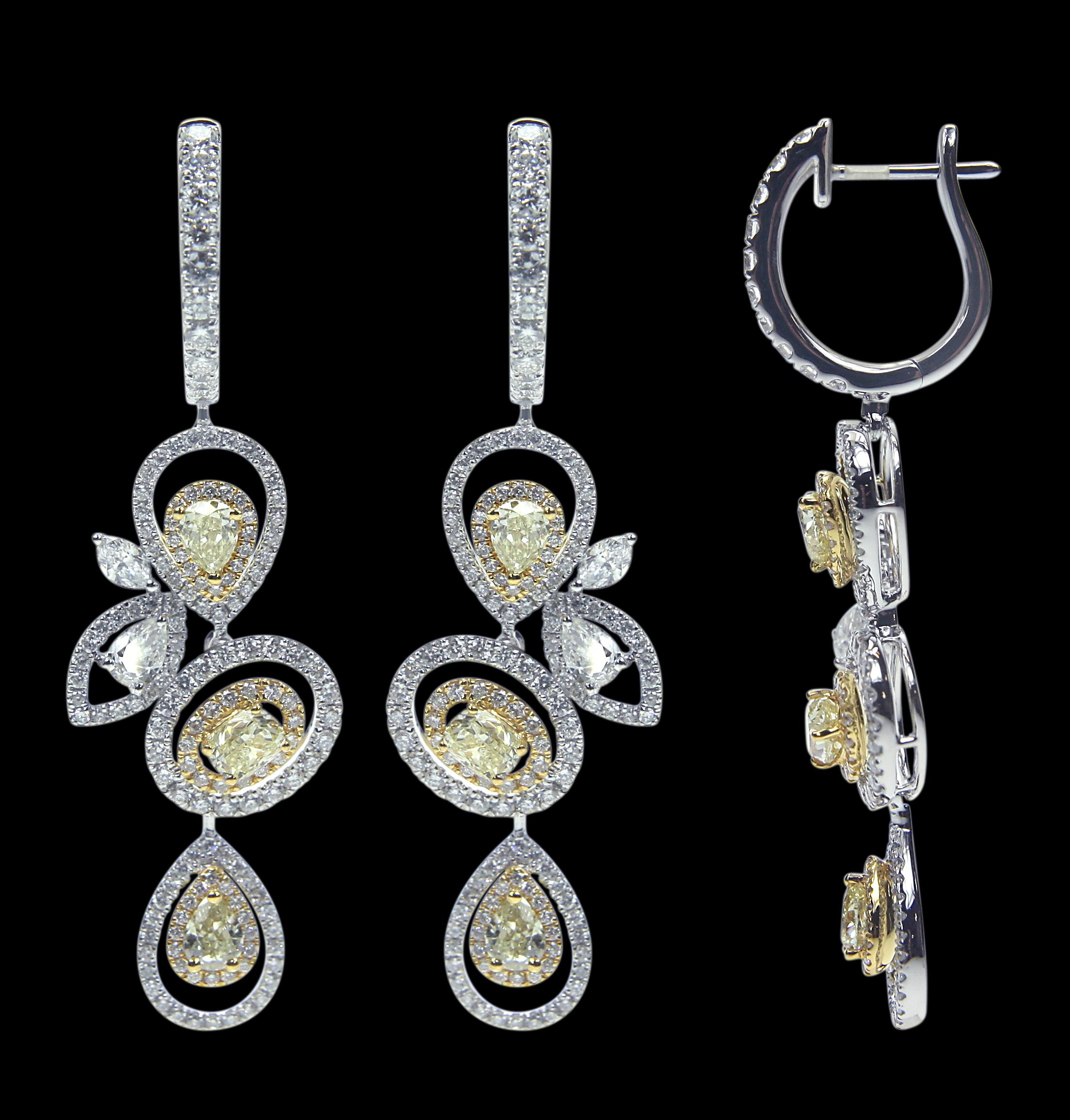 Tailor Made 18 Karat White And Yellow Gold, And Diamond Earring & Pendant Set.

Pendants:
Diamonds of approximately 2.418 carats mounted on 18 karat white yellow gold pendants. The pendant weighs approximately around 6.286 grams.
Earrings:
Diamonds