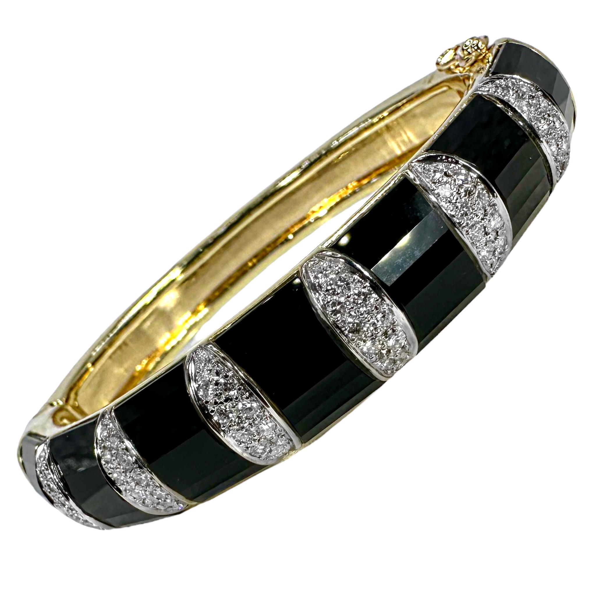 This beautiful and very well crafted 18k yellow gold bangle bracelet by well respected maker, La Triomphe is pure 1970's high style. Characteristic of their offerings, every element of this hinged bracelet is artfully done. Every diamond is set into