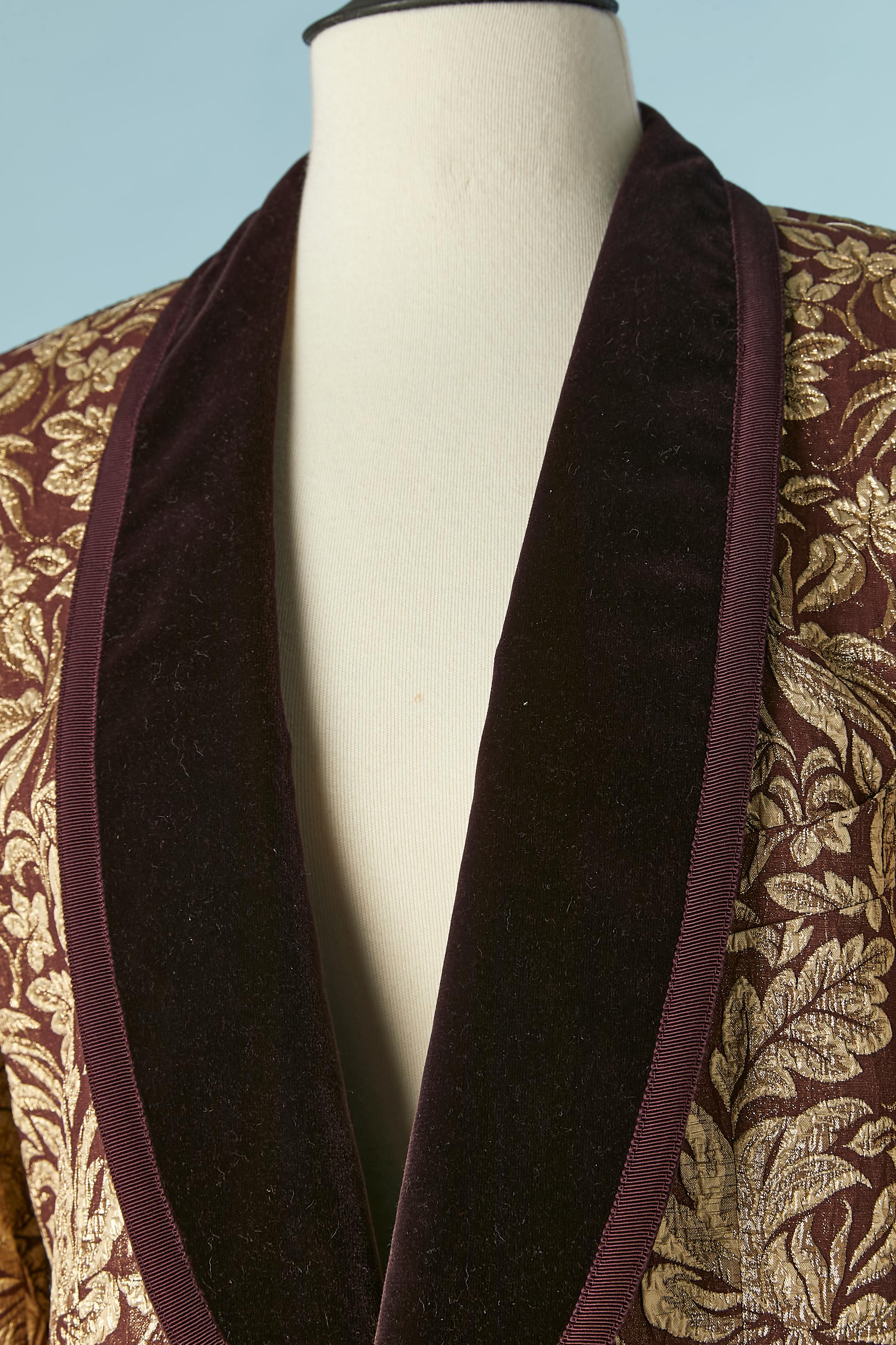 Tailored gold damask tuxedo jacket with burgundy velvet collar. Main fabric composition: 43% acetate, 39% silk, 18% polyester. 
Lining: 65% acetate, 35% rayon. 
One button ( covered with fabric) in the middle front. Shoulder-pad. 3 inside pocket.