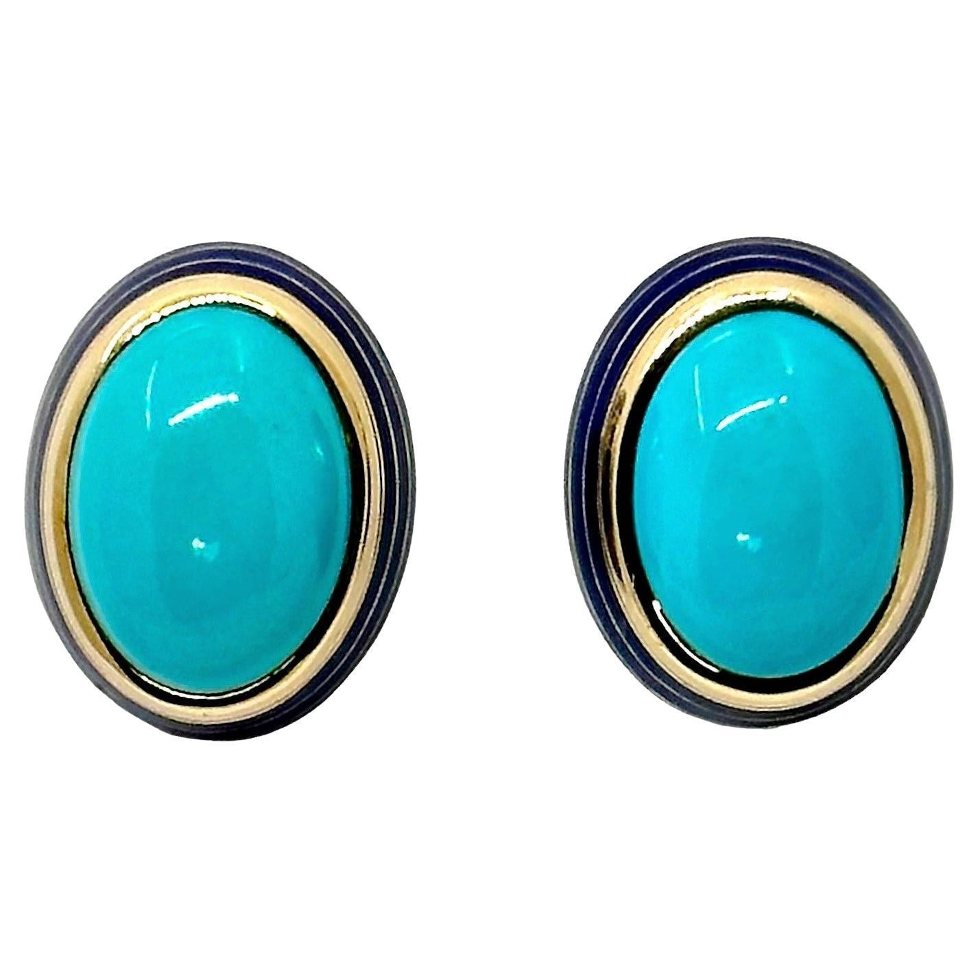 This very tasteful pair of 18K yellow gold earrings are deftly designed. At the center of each is a natural turquoise measuring over 3/4 inches in length and  just under 5/8 inches inches in width. The overall measurement of the earrings is 1 inch