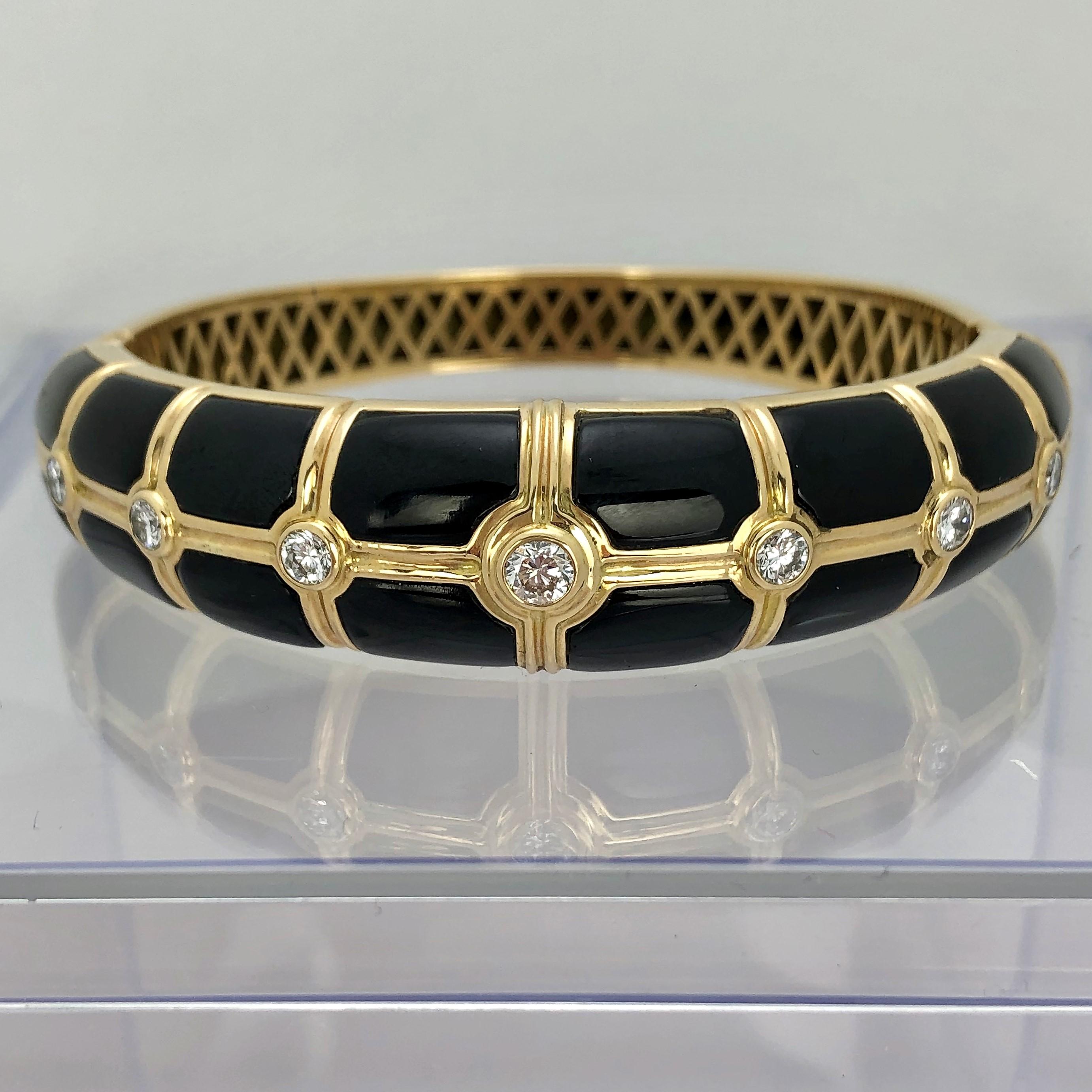 Beautifully crafted in 14K Yellow Gold with sixteen onyx inlays and set with seven round brilliant 
cut diamonds, this tailored, easy to wear bangle is ideal for every day use. The entire inside of
the bangle is finished off with a high quality,