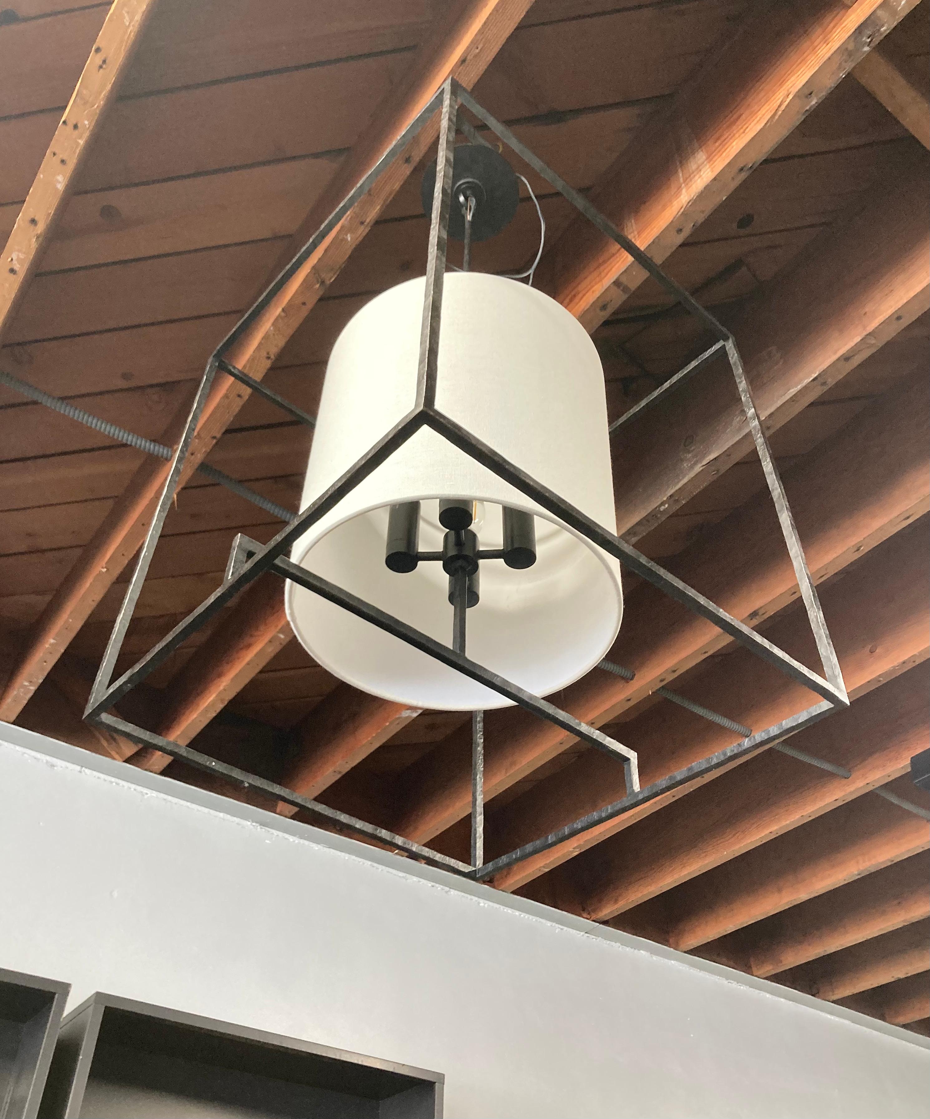 Large steel framed postmodern-style light fixture by Visual Comfort. 4 light sockets are covered with a linen shade. Steel frame has an antique hammered finish. Near brand-new condition, and not currently available for conventional retail.    