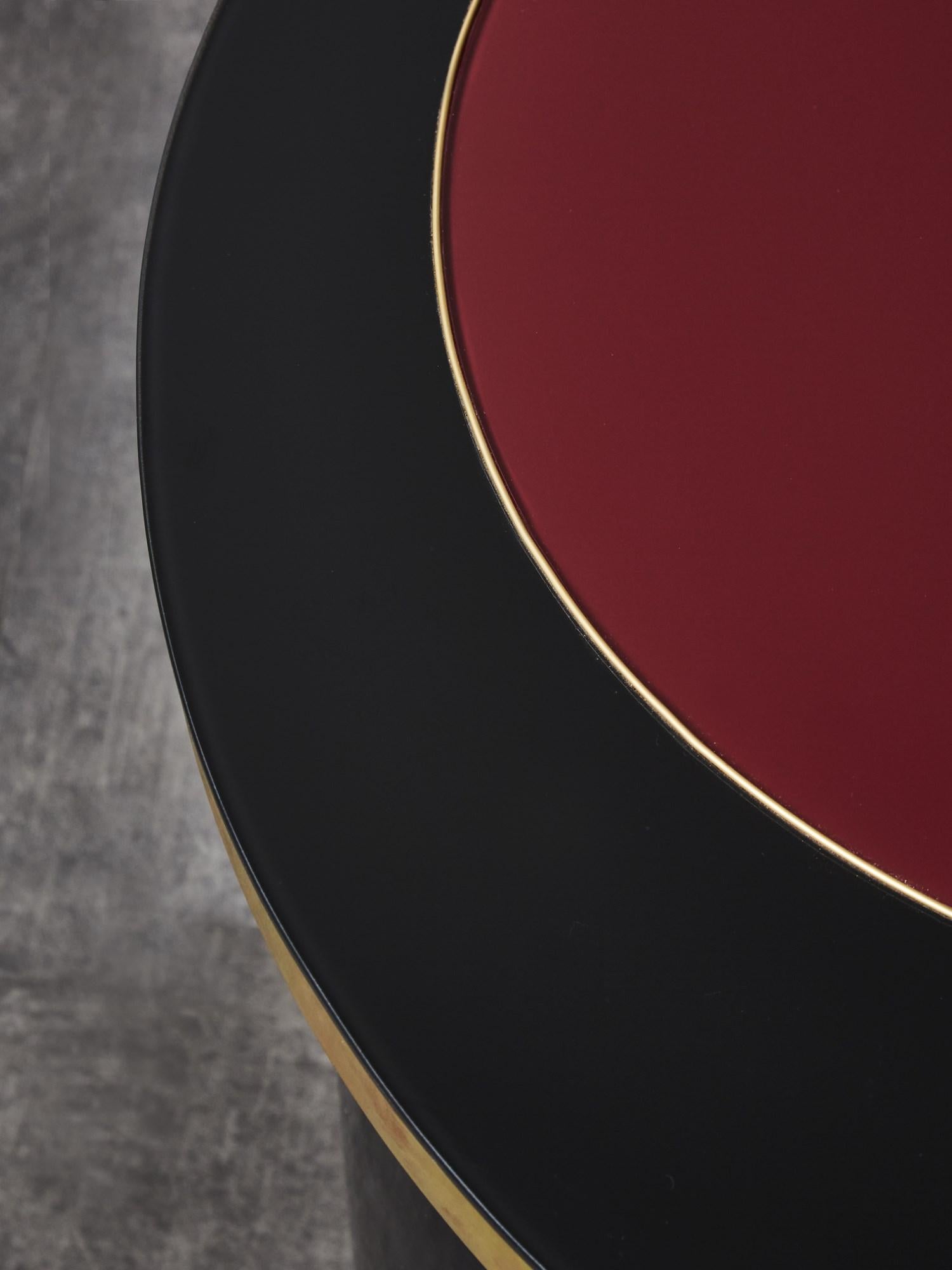 Piédestal en bois laqué noir, avec plateau en miroir teinté noir et rouge.