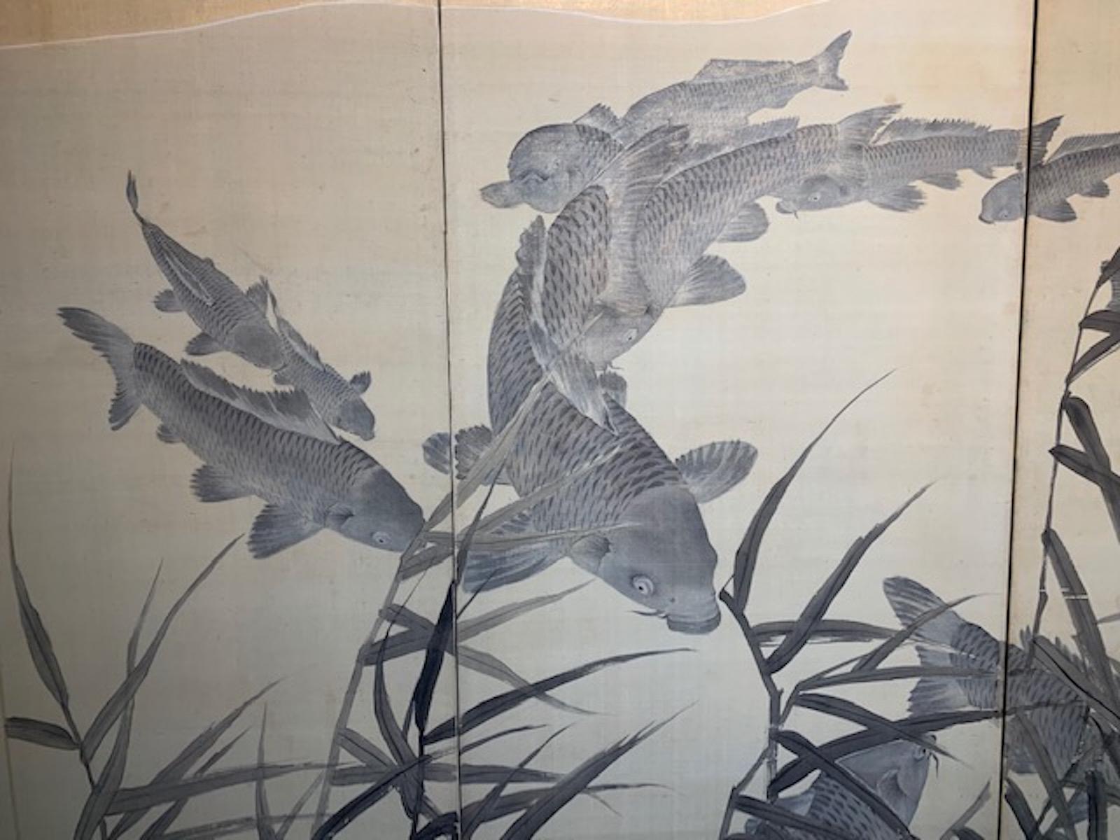 Four-panel Japanese screen depicting swimming Koi beneath the waters surface and gold sky. Brush painting on raw silk.