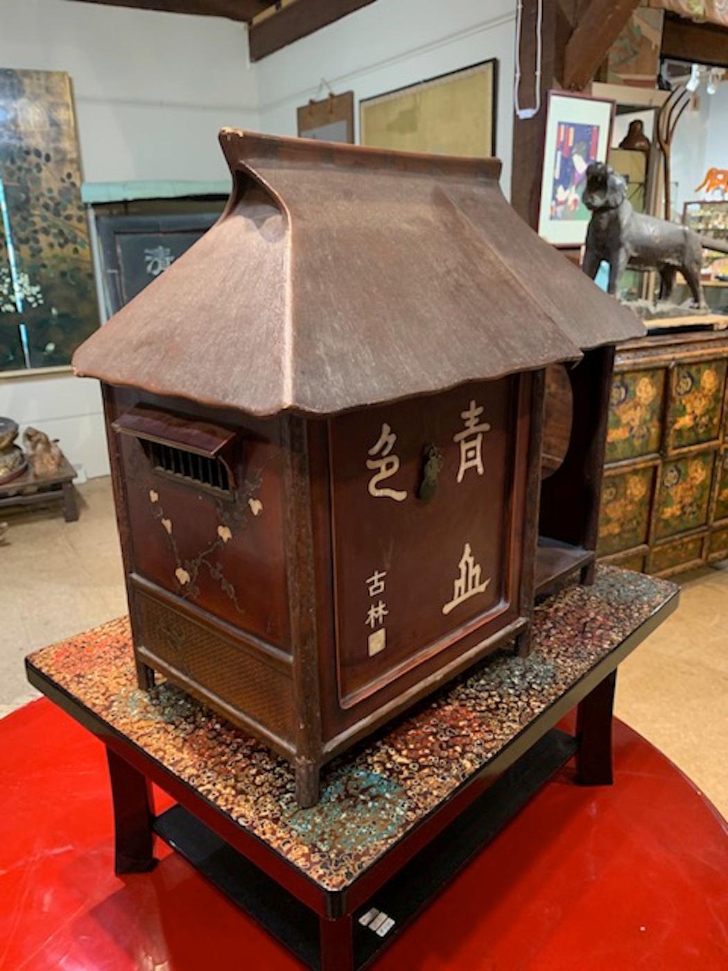 This tea chest is lacquered and inlayed with shell decorations. In the shape of a Japanese Minka or farmhouse - this cha dansu is from the Kyoto region and dates to the Taisho Period.