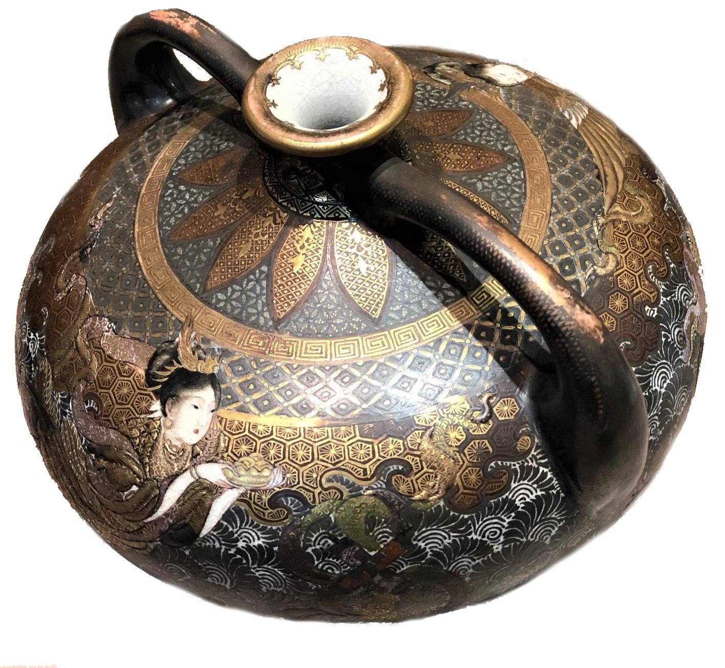 This beautiful end of Meiji Period Japanese Kyoto Fuzan Satsuma Ware double-handled vase has a gold plated intricate infinite circular relief pattern design and two images of goddess on both sides of the vessel.

Dimensions:
Height: 5.75 inches