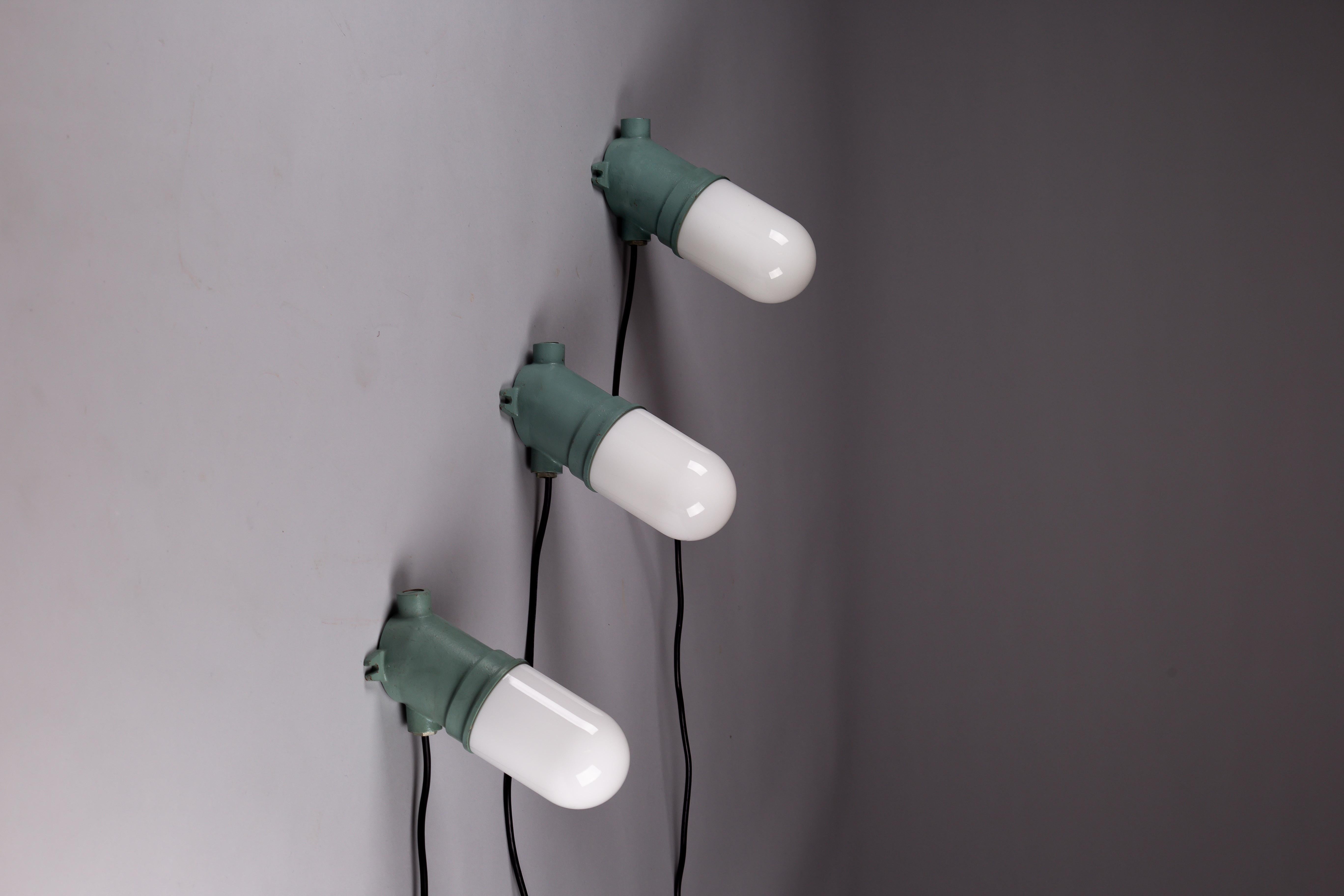 Industrial Taito Oy, set of three green 1930's cast iron industrial wall lamps