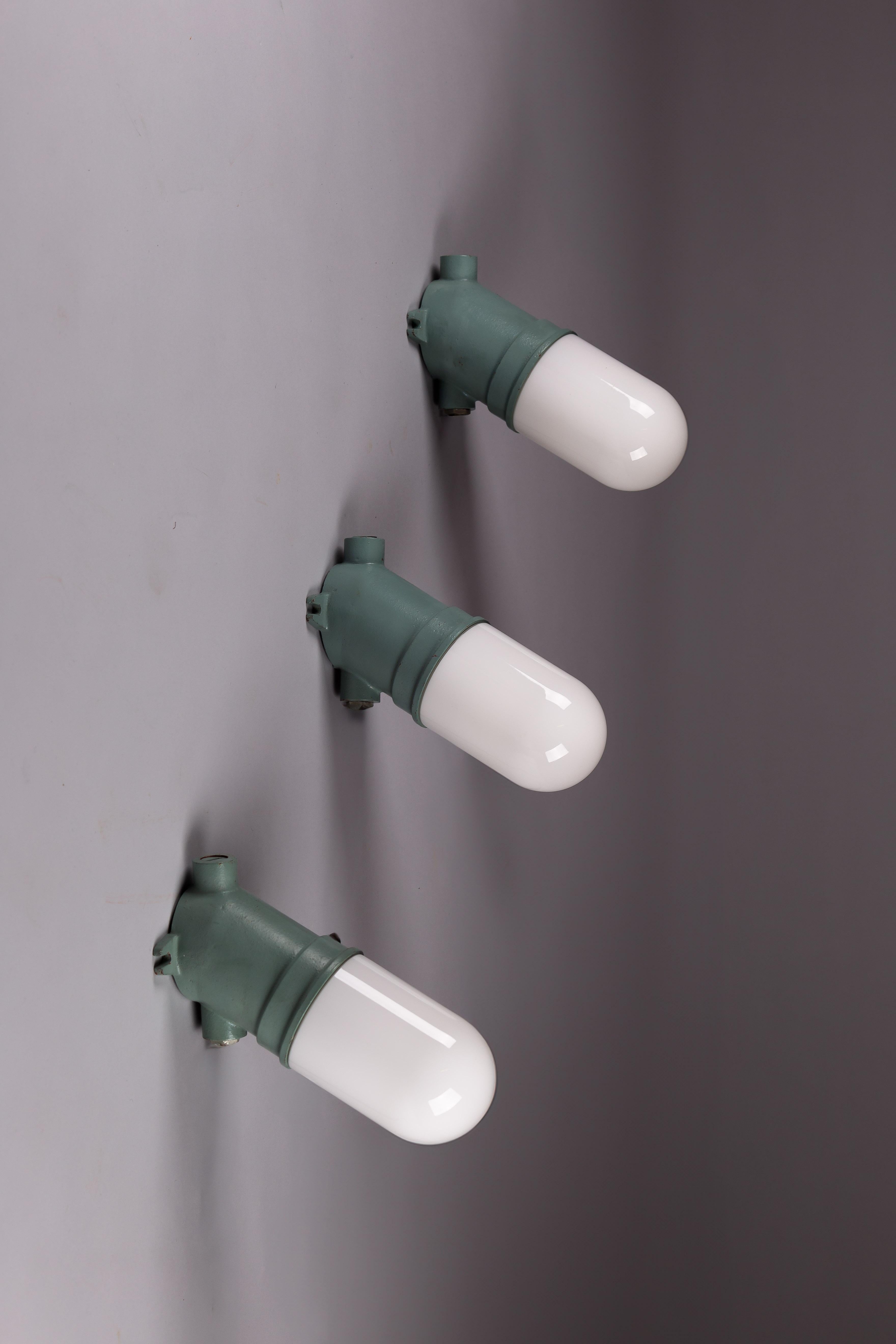 Opaline Glass Taito Oy, set of three green 1930's cast iron industrial wall lamps