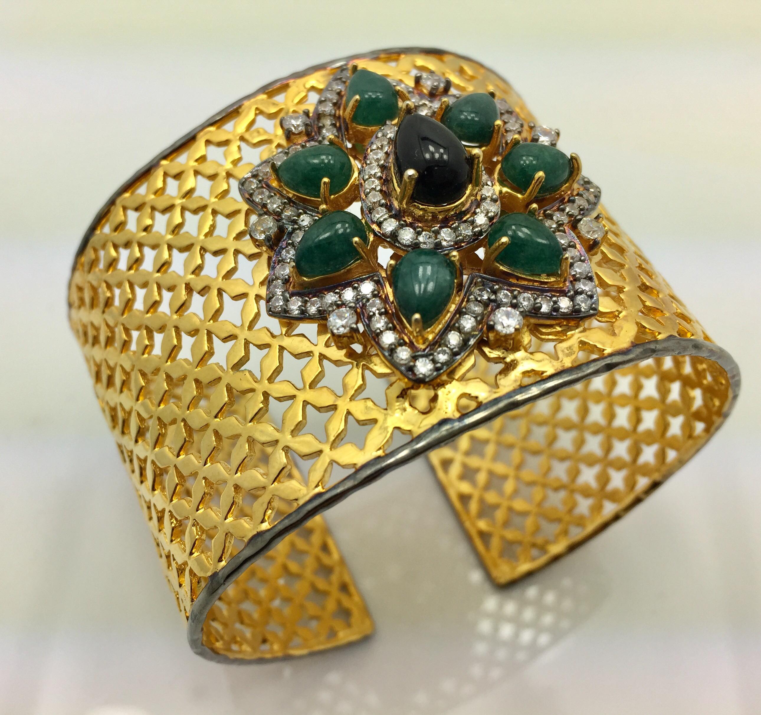 A stunning lattice cuff inspired by the beautiful Taj Mahal is embellished with green faux quartz and black onyx.  The intricate detail in handmade cuff is further enhanced with cubic zircon. Cuff is adjustable. 

FOLLOW  MEGHNA JEWELS storefront to