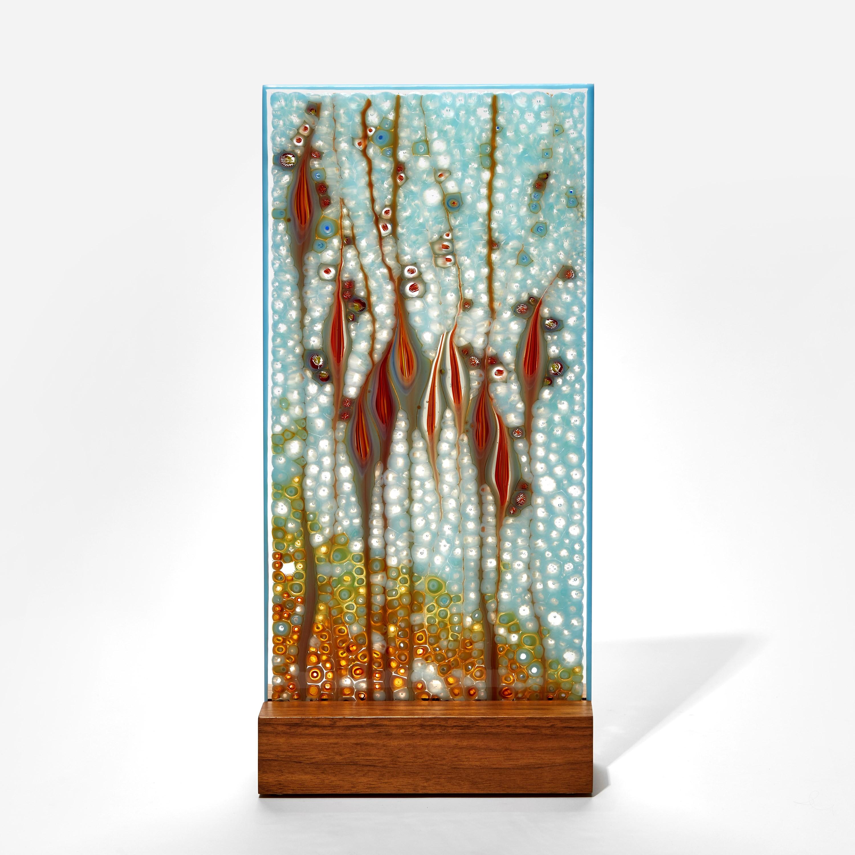 'Takamaka Opal', is a unique glass sculpture by the Austrian artist Sandra A. Fuchs, created in aqua, deep red and vibrant orange glass. Fuchs creates her own multi-colored and complex glass canes, which are then cut to create small 'murrina'. These