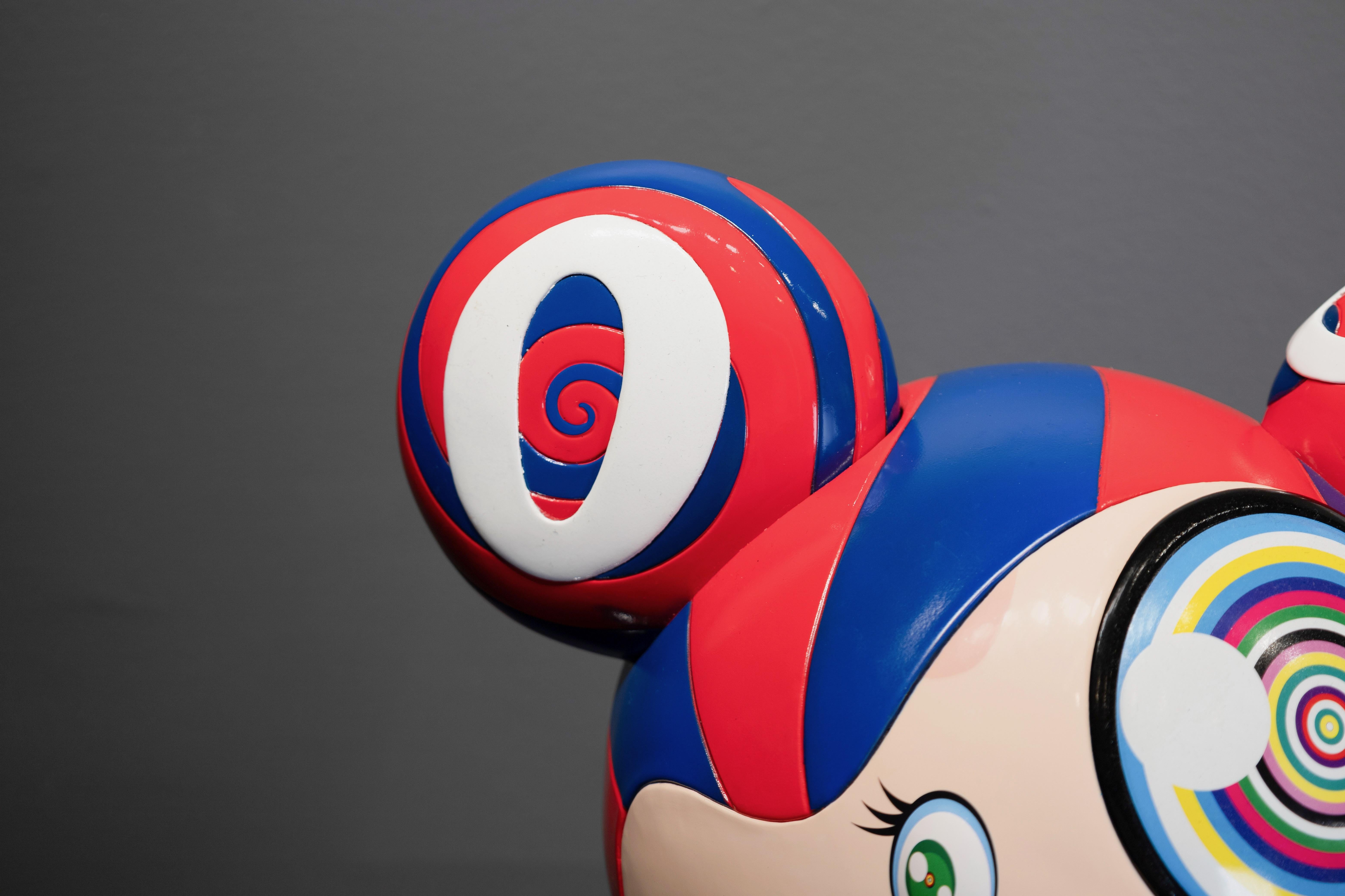 'ComplexCon: Mr. Dob' (Red/Blue), is a vivid and thought-provoking sculpture that reflects Takashi Murakami’s ongoing exploration of the intersection between fine art, pop culture, and consumerism. Through its bright red and blue color palette,