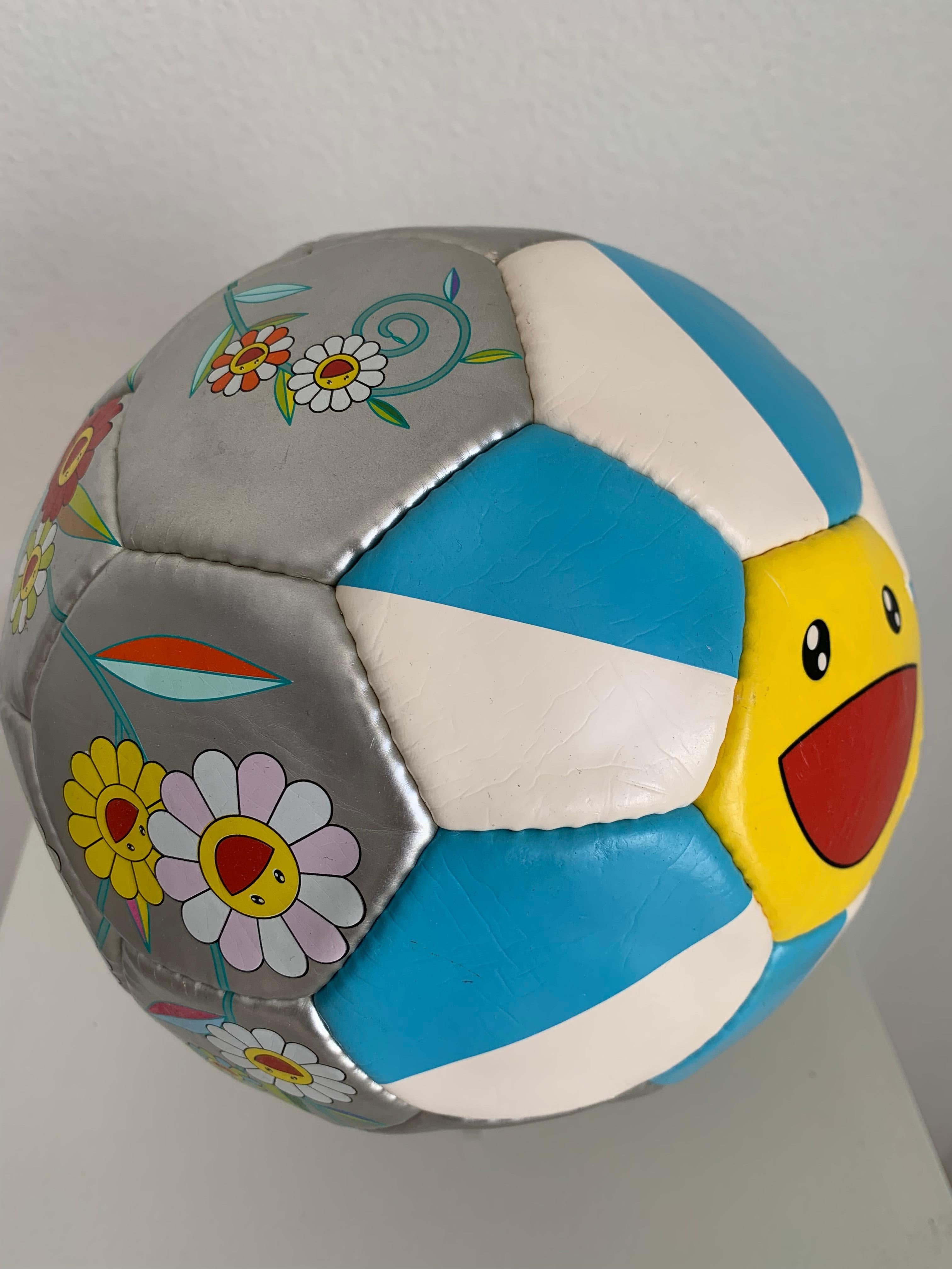 Soccer Flower Ball (2002) by Takashi Murakami
Offset Lithograph on Soccer Ball with Vinyl Bag
9 inches (22.9 cm) Diameter
Limited Edition of Unknown Size
Signed with printed manufacturer's mark to ball 'Molten Made in China 2002 Takashi Murakami/Kai