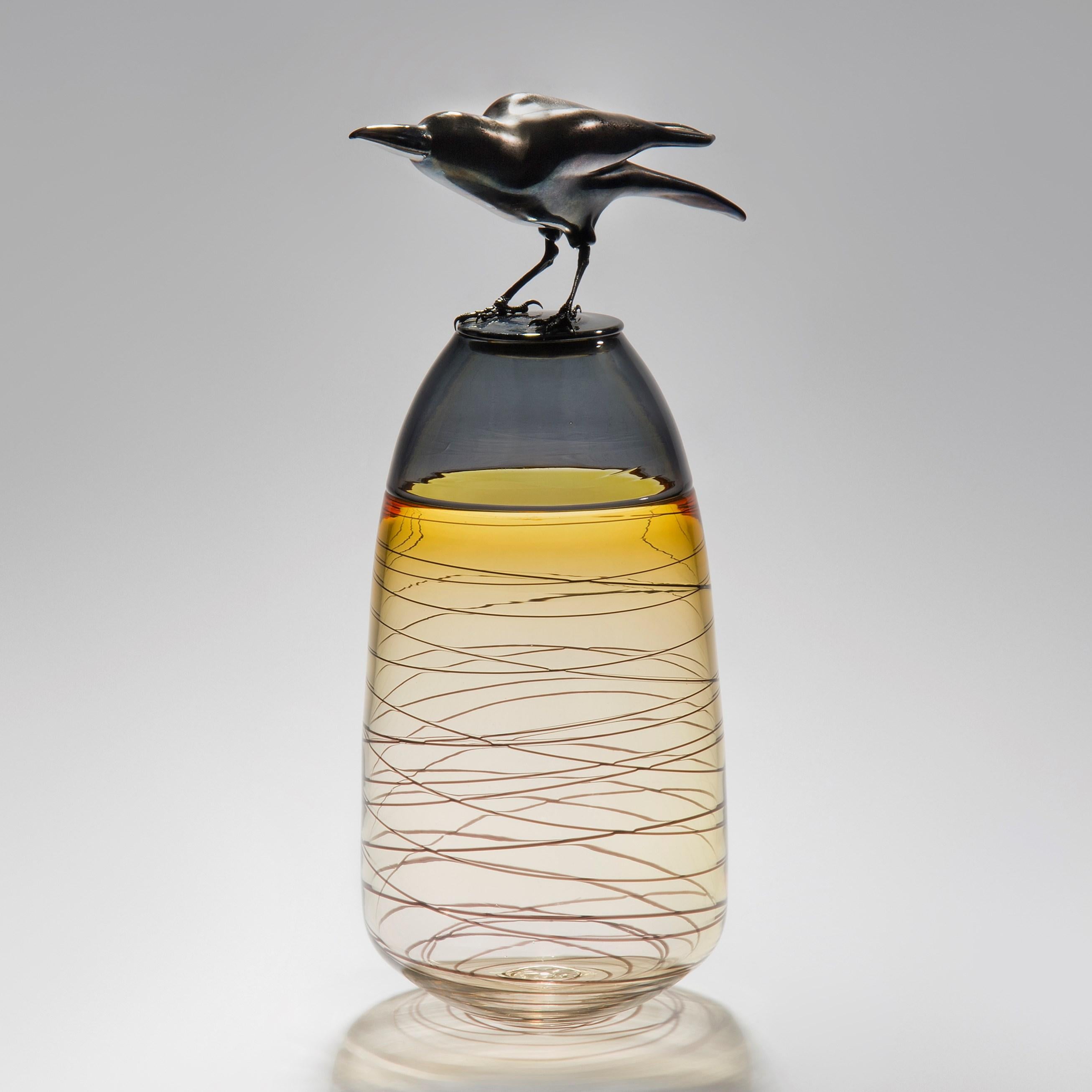 Take Off, is a handblown art glass vase in amber with removal lid adorned with a hot sculpted black glass crow by the British artist Julie Johnson. The crow figurine can also be lifted off with the main body leaving a functioning vase.

Following on