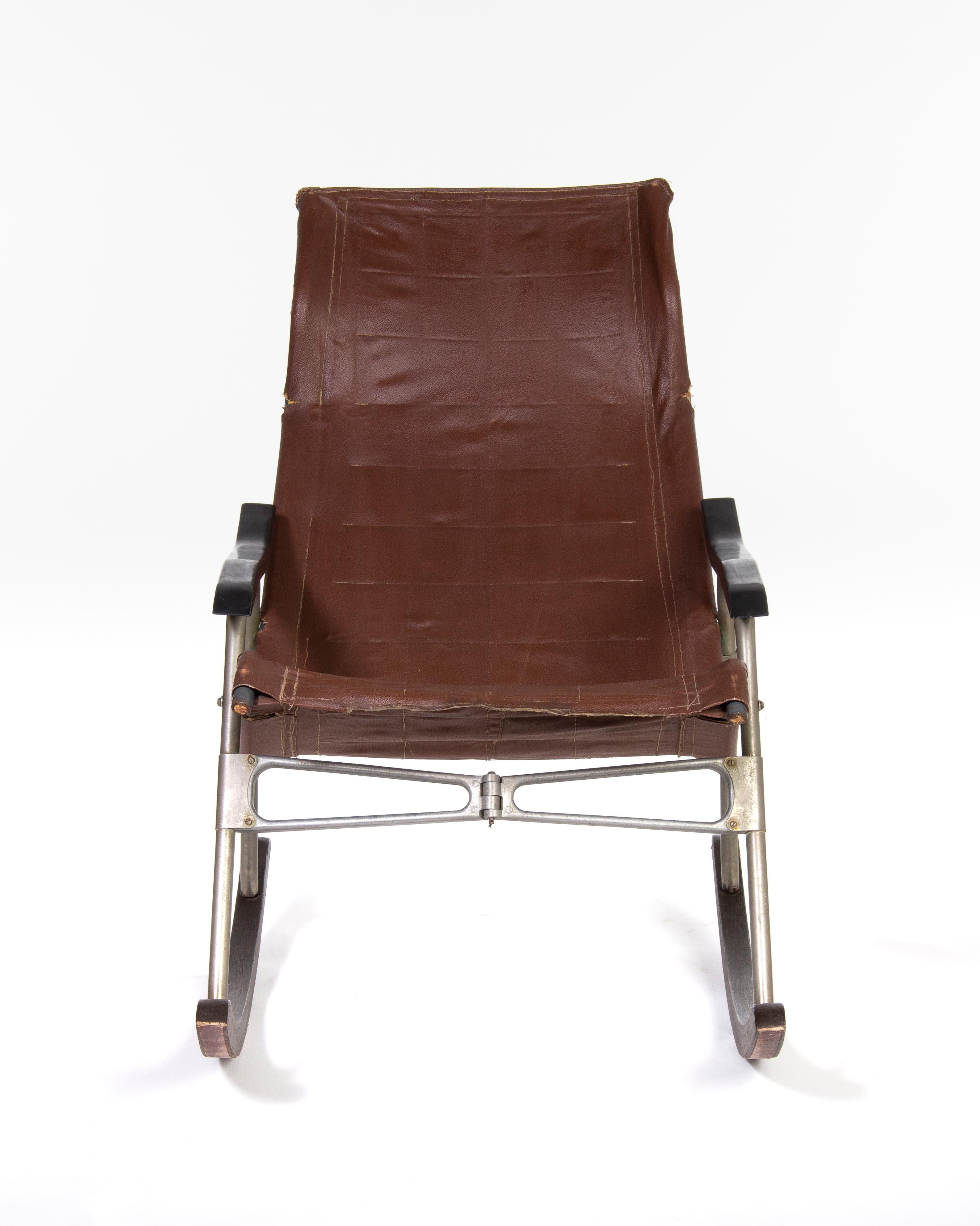Brown leather rocking chair, designed by Japanese Takeshi Nii in the 1950s.
The chair is foldable in the middle to collapsed state of 14 cm width.
 