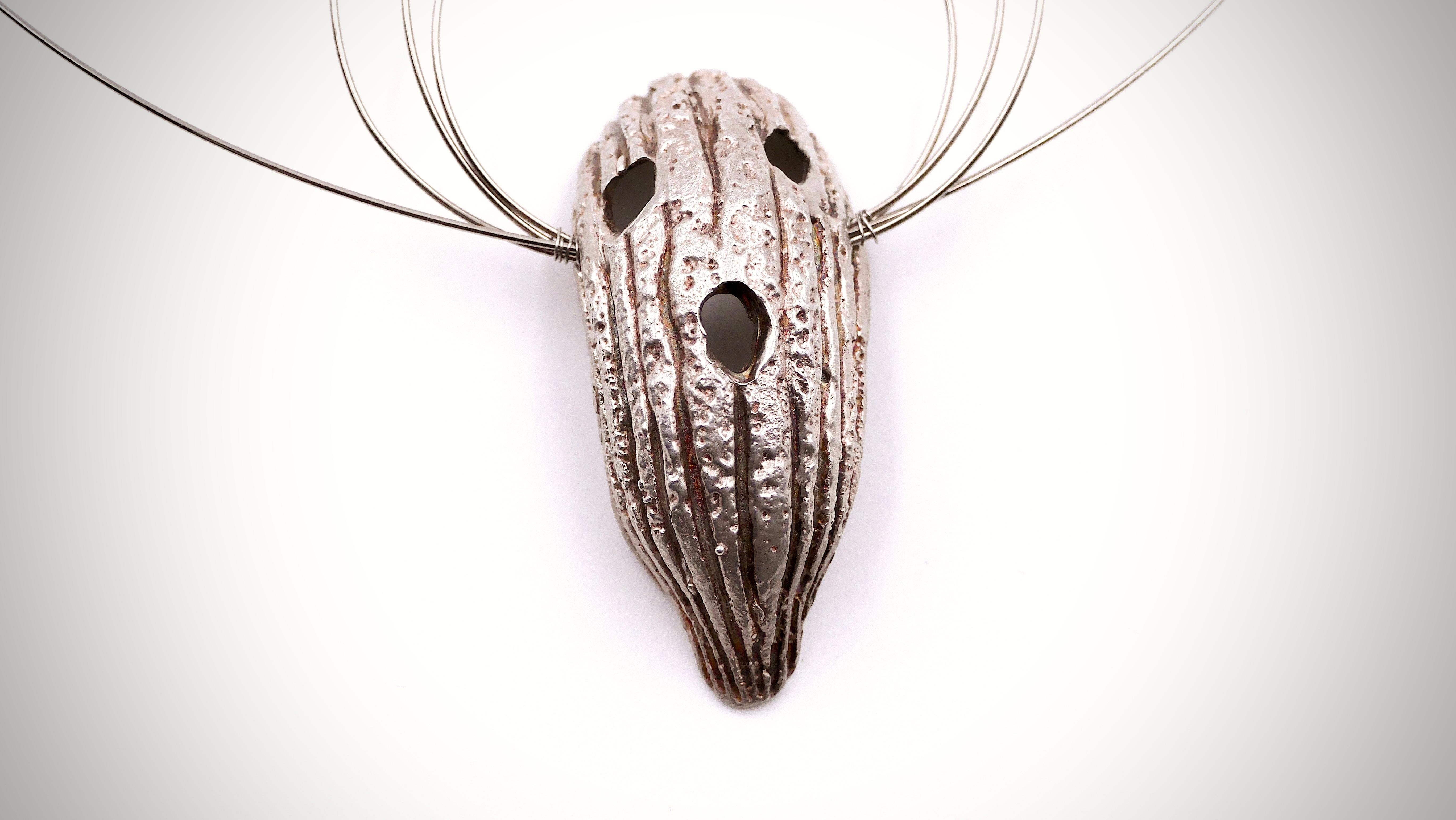 Unique  abstract silver pendant with mask on a steel torque.
2011
With certificate from Medusa Art Gallery Athens

Panayiotis Vassilakis (Greece, 1925 -2019) which artistic name is TAKIS was a luminary in the realm of artistic innovation, has