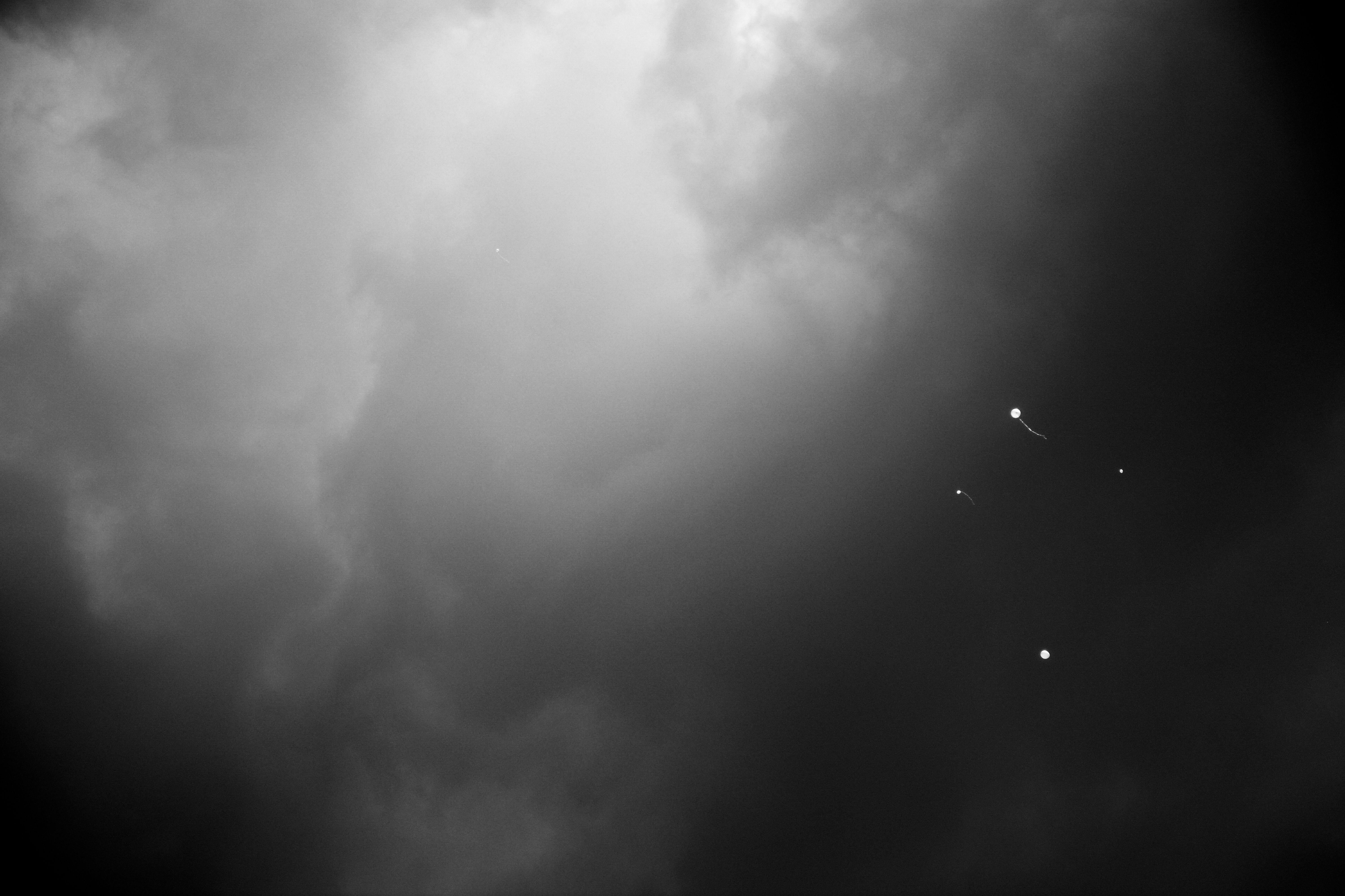 Tal Paz-Fridman Black and White Photograph - Four balloons and another one, Photograph, Archival Ink Jet