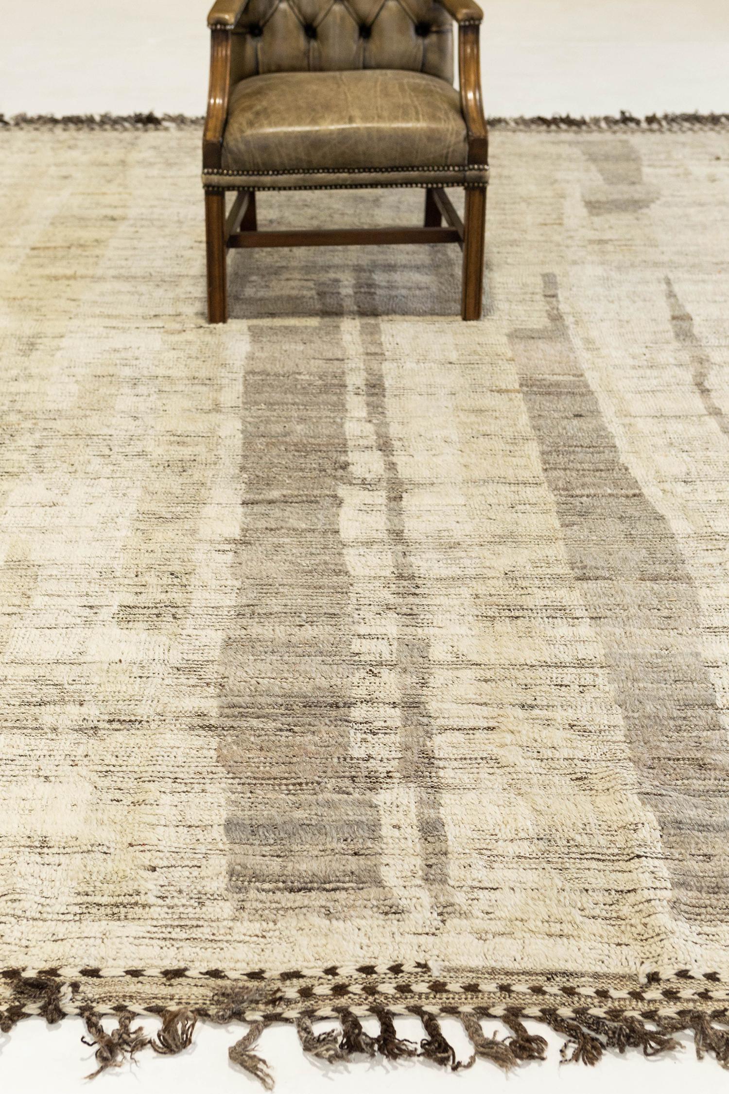 'Talassemtane' is a beautifully textured rug with irregular motifs inspired from the Atlas Mountains of Morocco. Taupe and sepia tan surrounded by the perfect white shag work cohesively to make for a great contemporary interpretation for the modern