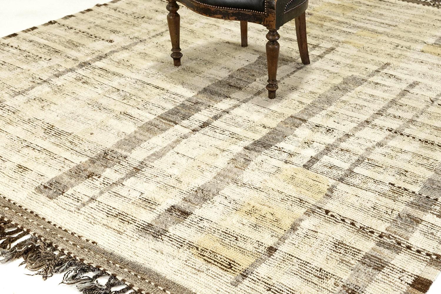 'Talassemtane' is a beautifully textured rug with irregular motifs inspired from the Atlas Mountains of Morocco. Natural brown and gray colors surrounded by the perfect ivory shag work cohesively to make for a great contemporary interpretation for