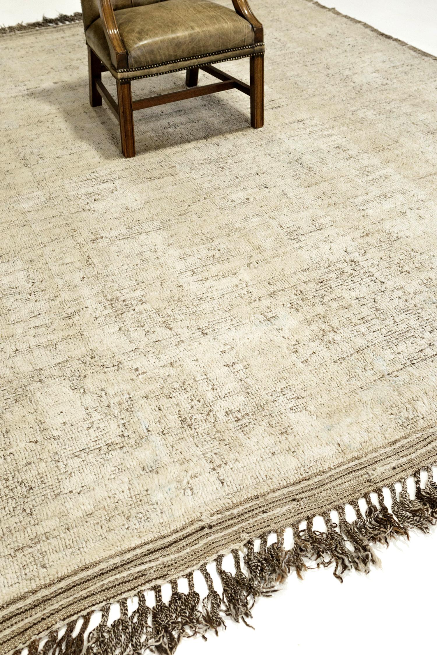 'Talassemtane' is a beautifully textured rug with muted irregular motifs inspired from the Atlas Mountains of Morocco. Golden tan colors surrounded by the perfect ivory shag work cohesively to make for a great contemporary interpretation for the