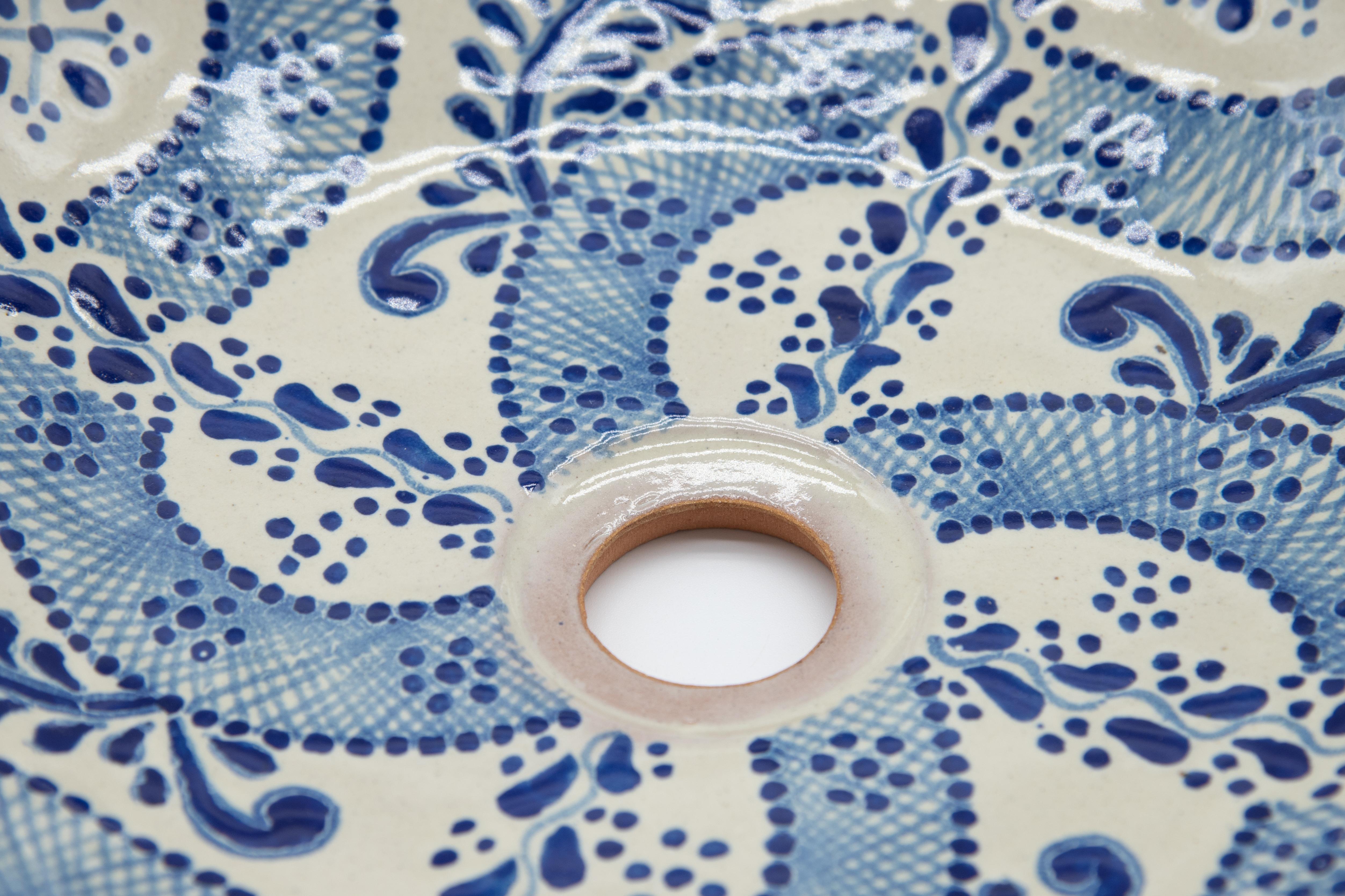 Elegant white and blue sink lavabo made with the Talavera technique. Artist, Cesar Torres portraits the colonial art of Mexico. 

The Talavera is not just a simple painted ceramic: its exquisite decoration is the product of a delicate process of