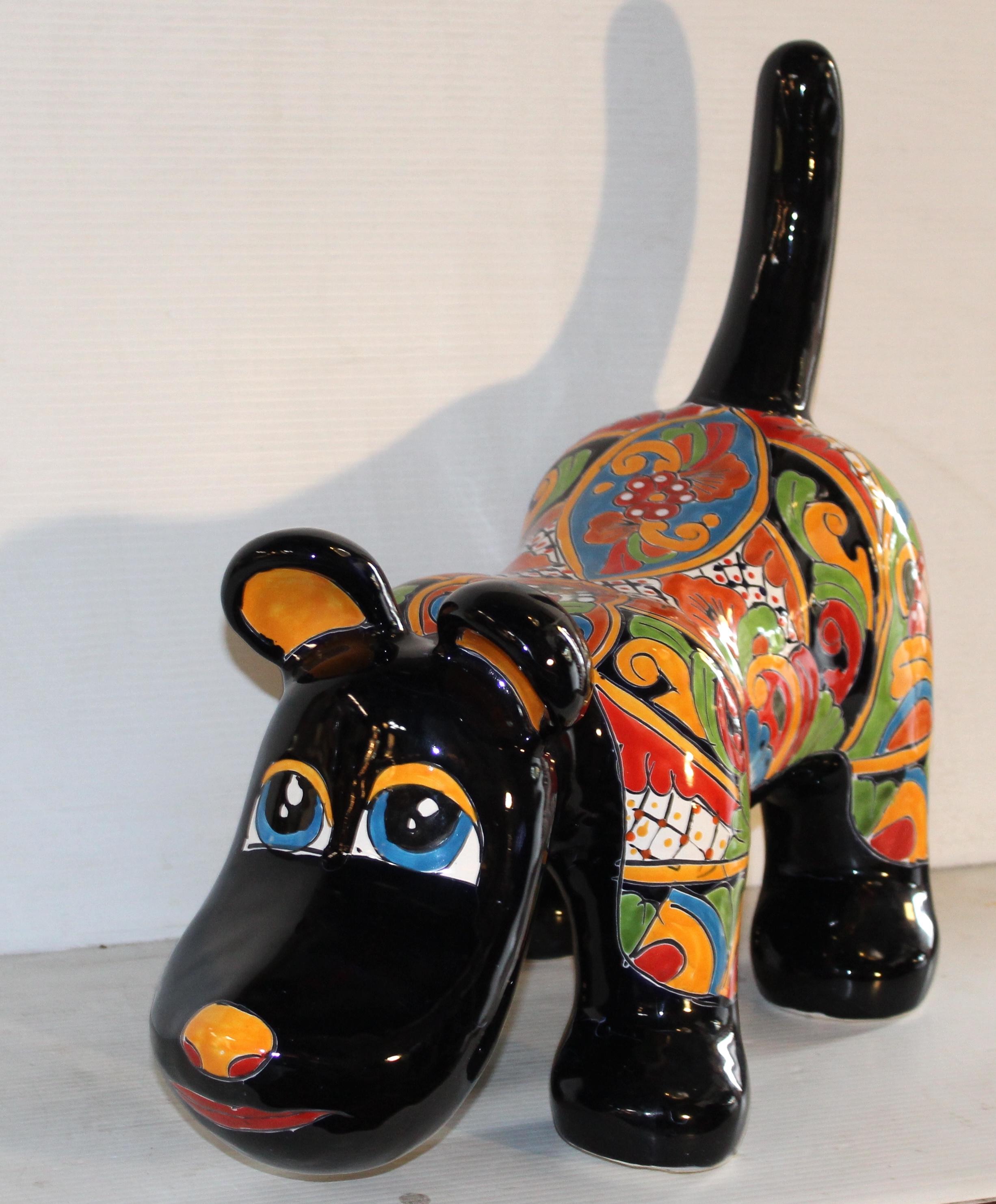 This Mexican style dog sculpture features brightly painted patterns on a black background. Colorful glazed pottery, great for indoor or outdoor use.
This pup really pops!
Please confirm location NY or NJ