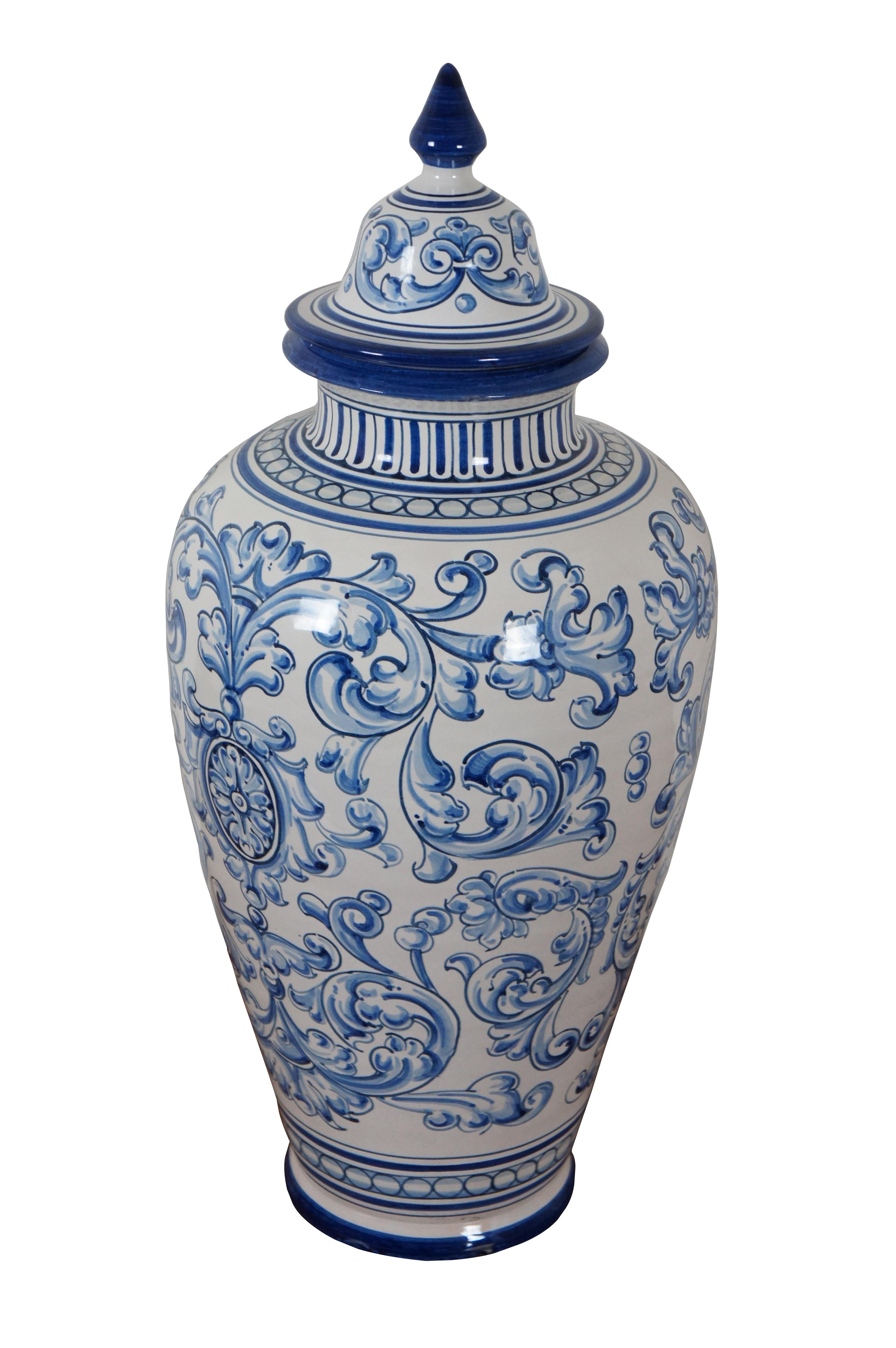 Vintage Spanish Talavera El Carmen folk art pottery, ceramic lidded mantel urn. Traditional urn shape beautifully decorated with blue and white foliate swirls and designs. Signed on base.

Dimensions:
10” x 21.5” (Diameter x Height)