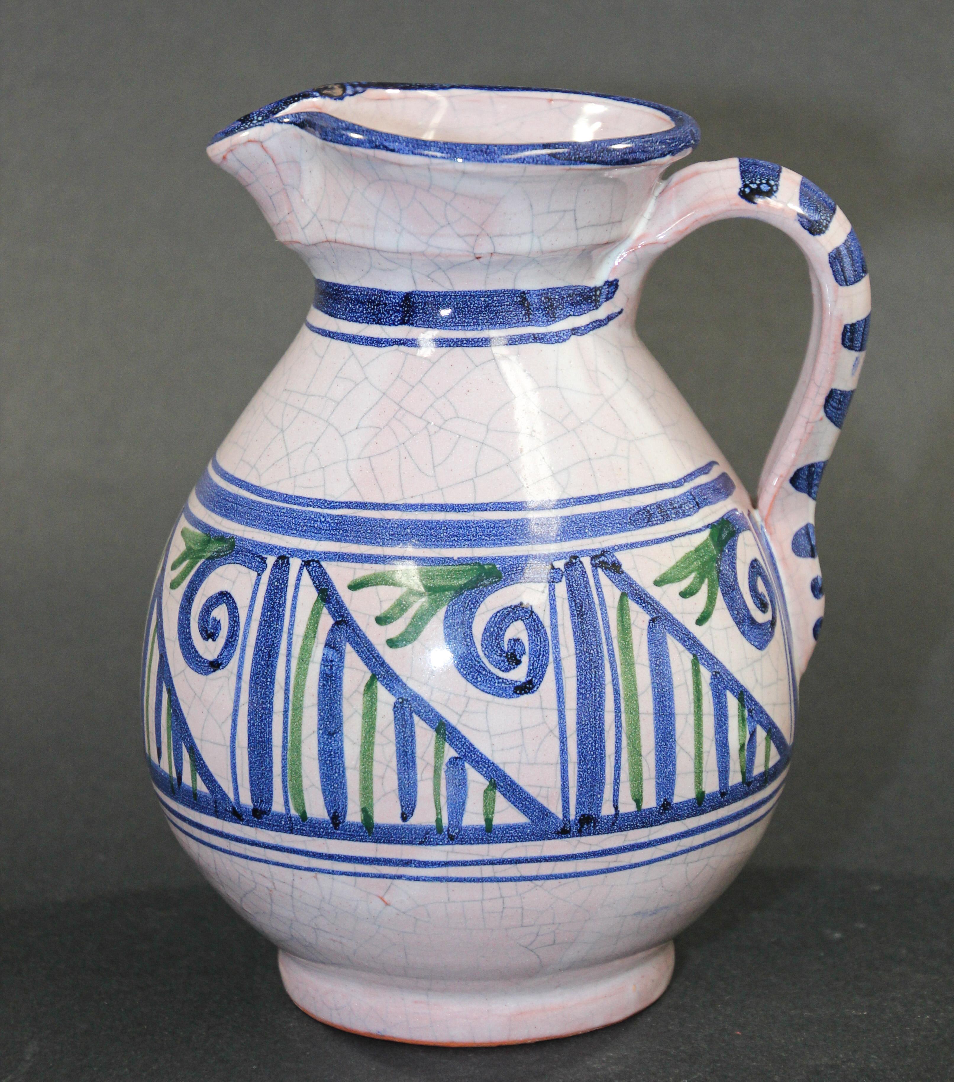 Glazed polychrome ceramic Talavera pitcher or flower vase with blue, green and white design.
Hand painted Talavera ceramic pitcher, handcrafted by skilled artisans in Spain in the Picasso style.
Unique vintage piece of traditional Spanish Talavera