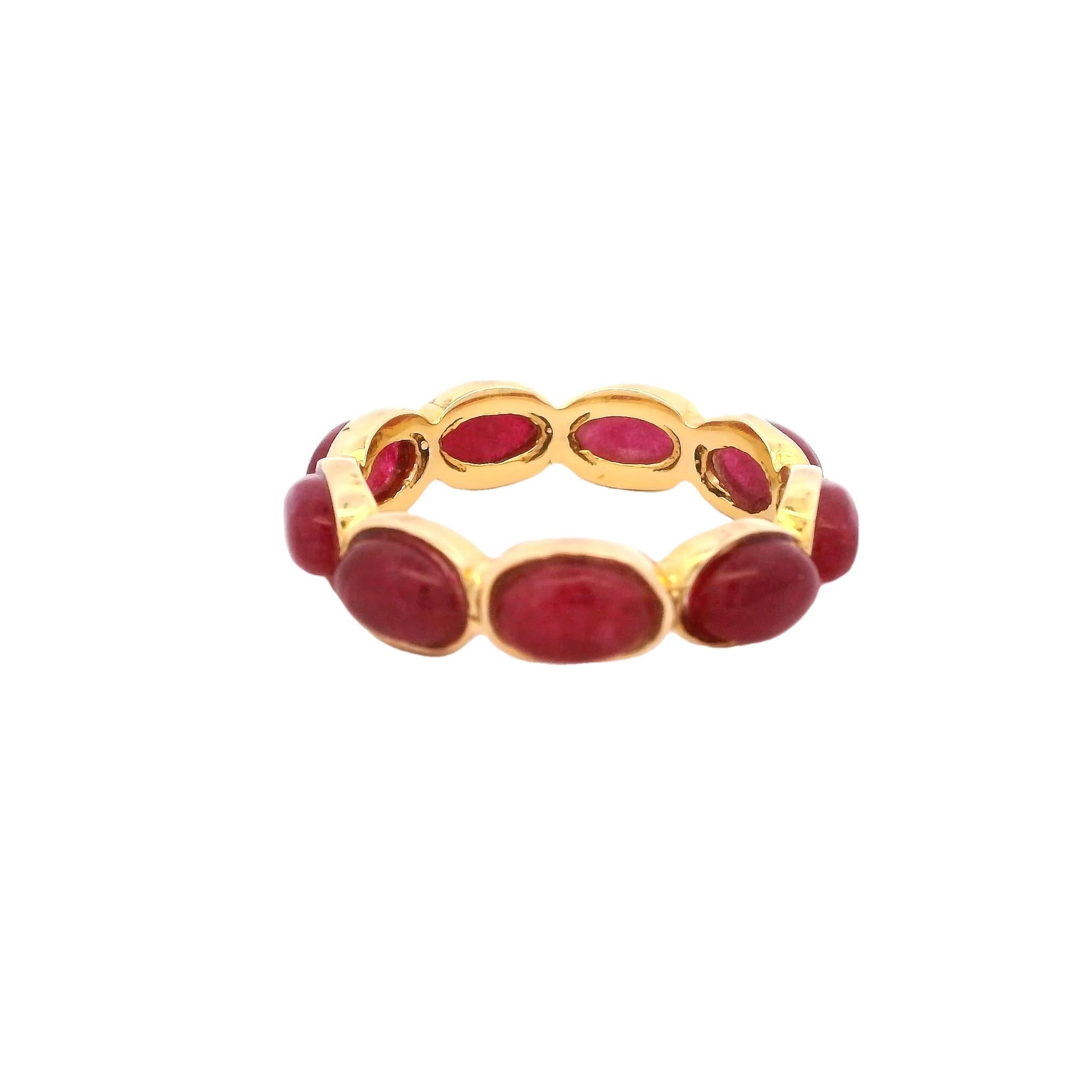 A refined and vibrant eternity band from Talia Jade, showcasing approximately 3 carats of deep pink-red cabochon rubies set in rich 14K yellow gold. Each oval ruby is bezel-set in a seamless continuous design, forming a bold yet elegant silhouette