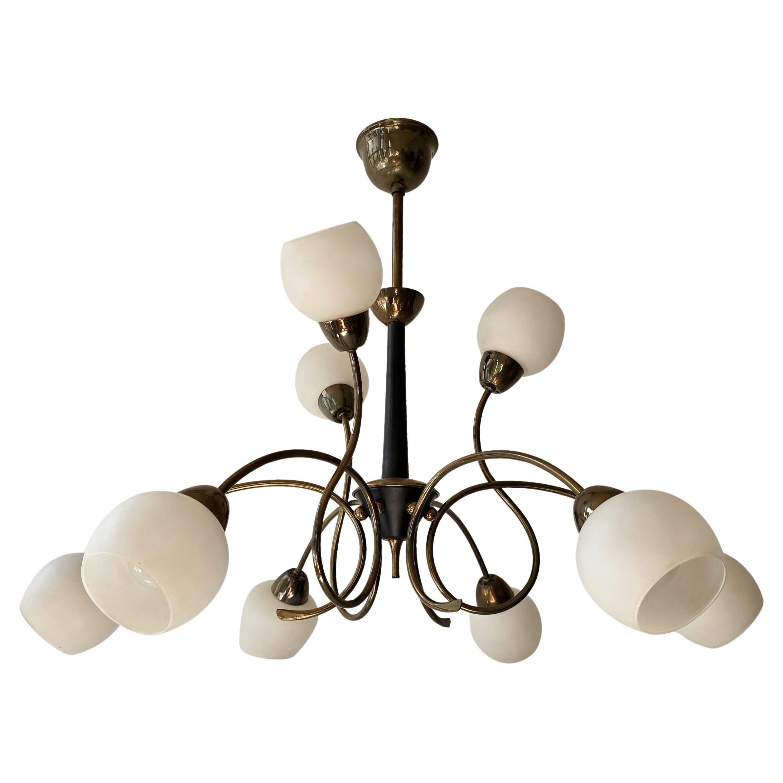 Italian 1950s Stilnovo Style Brass and Opaline Glass Nine-Light Chandelier

Elegant mid-century Italian chandelier in the style of Stilnovo, crafted in the 1950s. The design features nine hand-blown opaline glass shades mounted on gracefully curved