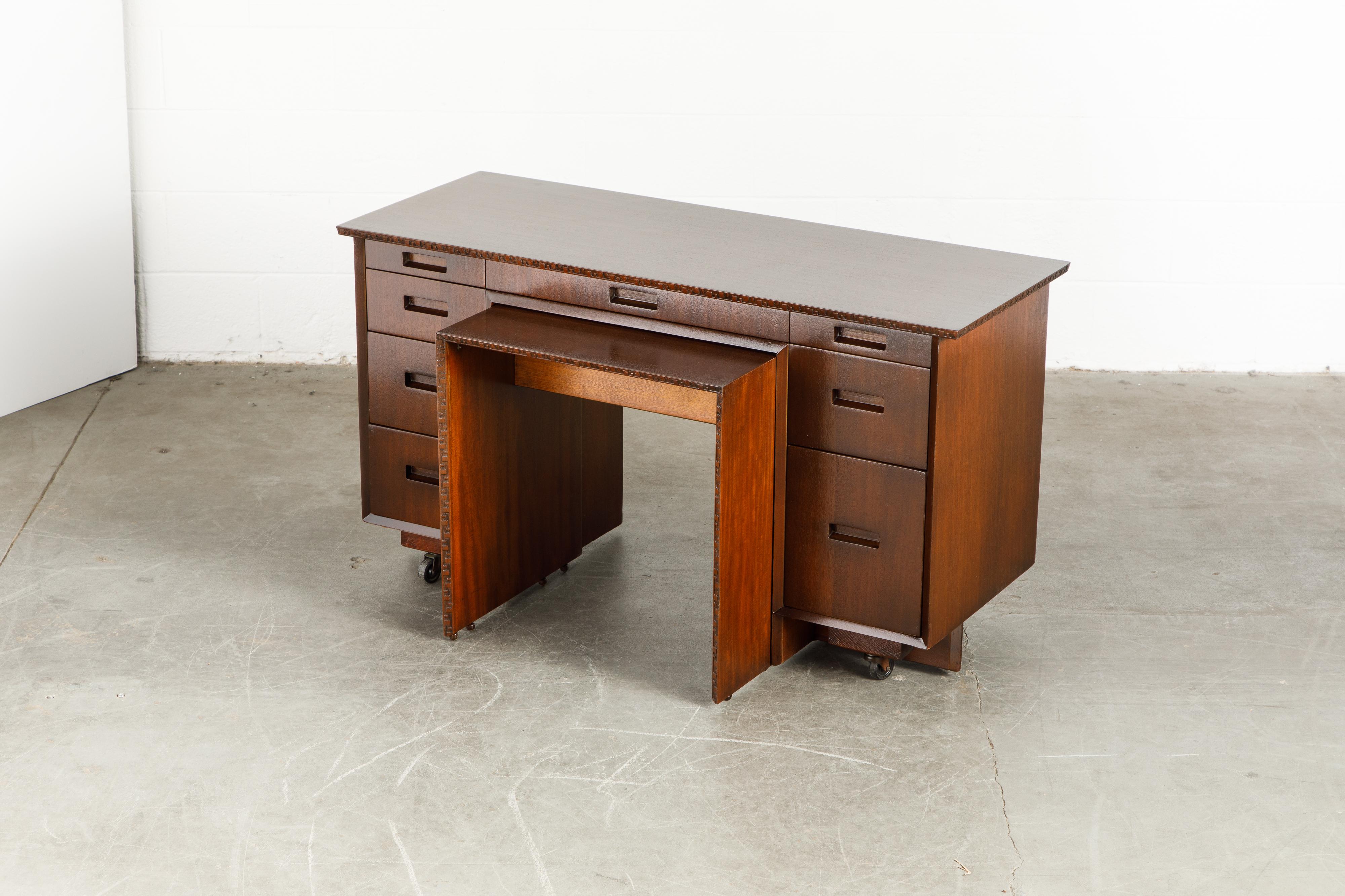 This gorgeously refinished Honduran Mahogany 'Taliesin' desk with pull-out table was designed by Frank Lloyd Wright for Heritage-Henredon in 1955 and produced only for two years, therefore is now a highly sought-after and rare collectors item. This