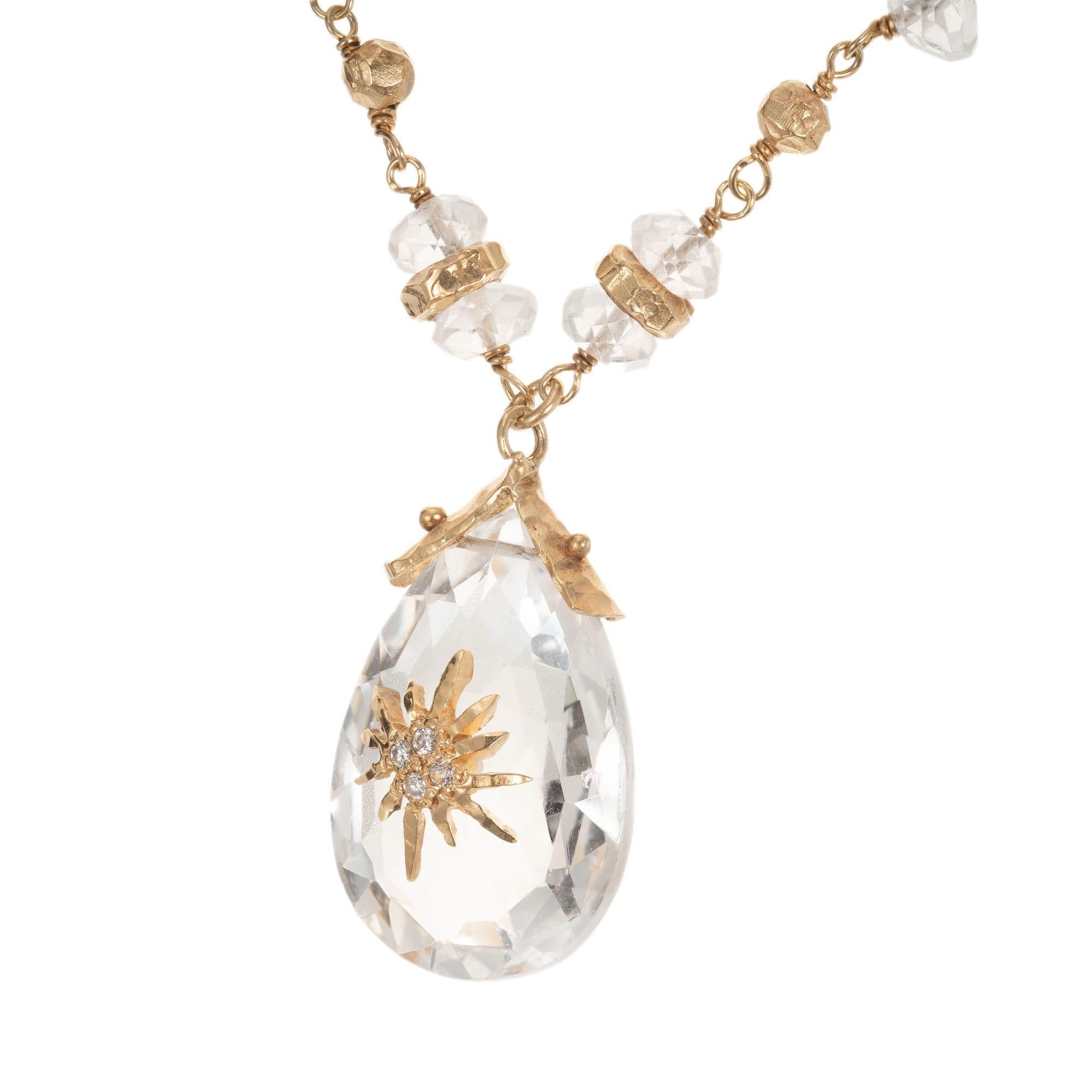 Quartz and diamond pendant necklace. Pear shaped quartz with 4 round accent diamonds and 32 faceted crystal beads. Handmade with hand hammered gold beads and spacers, hand wired stones and a handmade toggle and cap for the center stone.  Chain