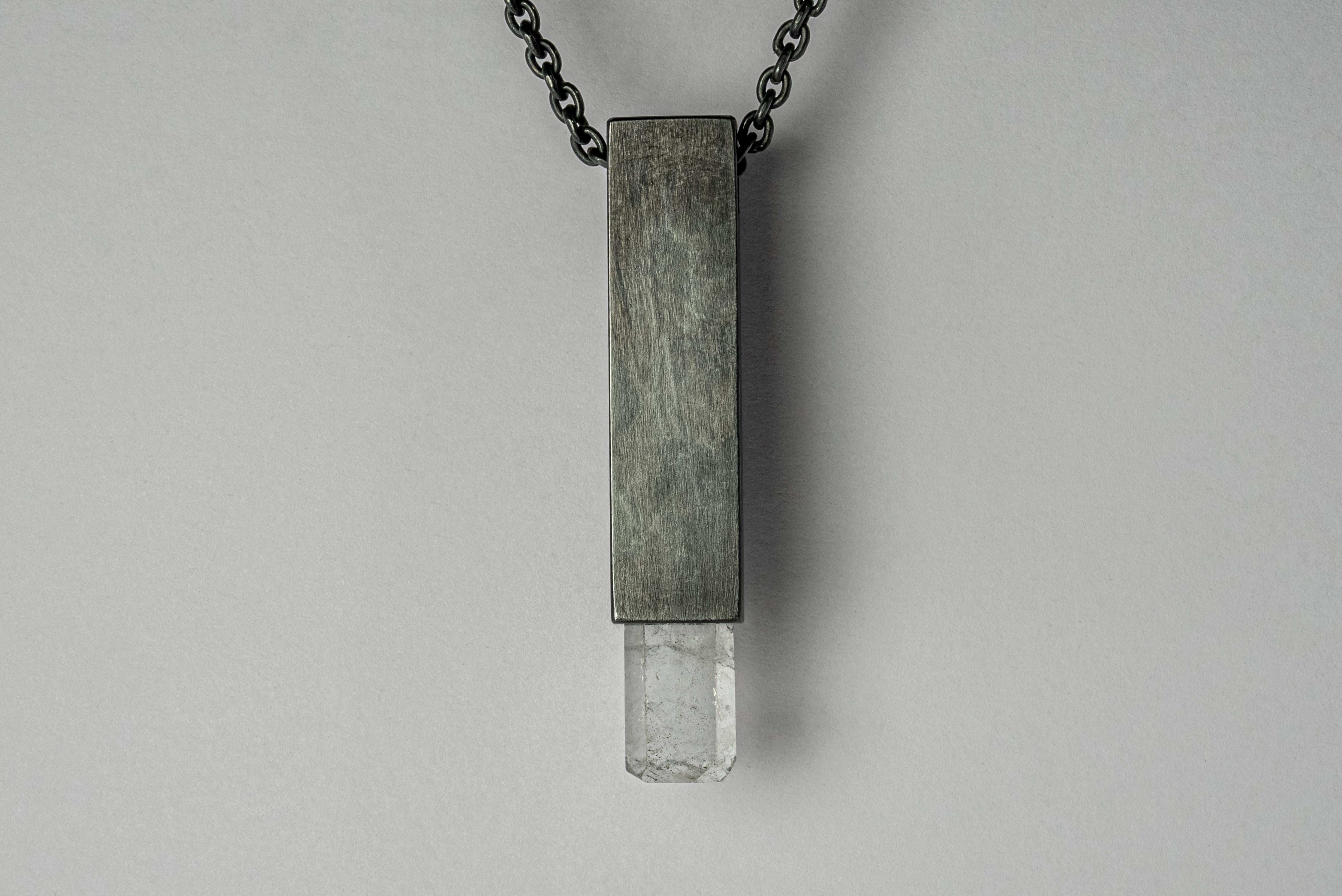 Necklace in the shape of cuboid made in oxidized sterling silver and a rough of aquamarine. The Talisman series is an exploration into the power of natural crystals. Tools for Magic. The crystals used in these pieces are discovered through adventure