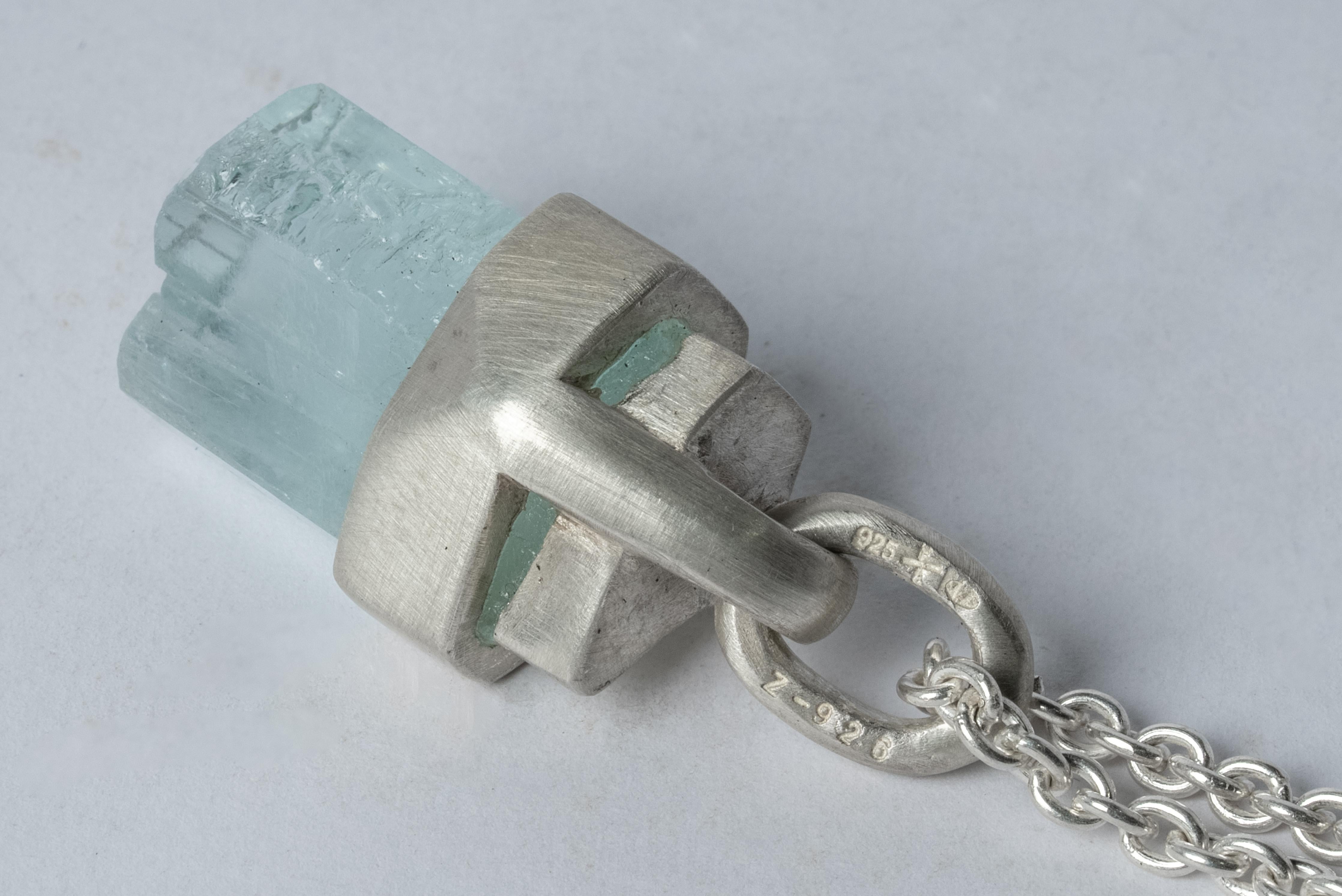 Talisman necklace in matte sterling silver and a rough of aquamarine. The Talisman series is an exploration into the power of natural crystals. The crystals used in these pieces are discovered through adventure and are hand selected. Each piece is