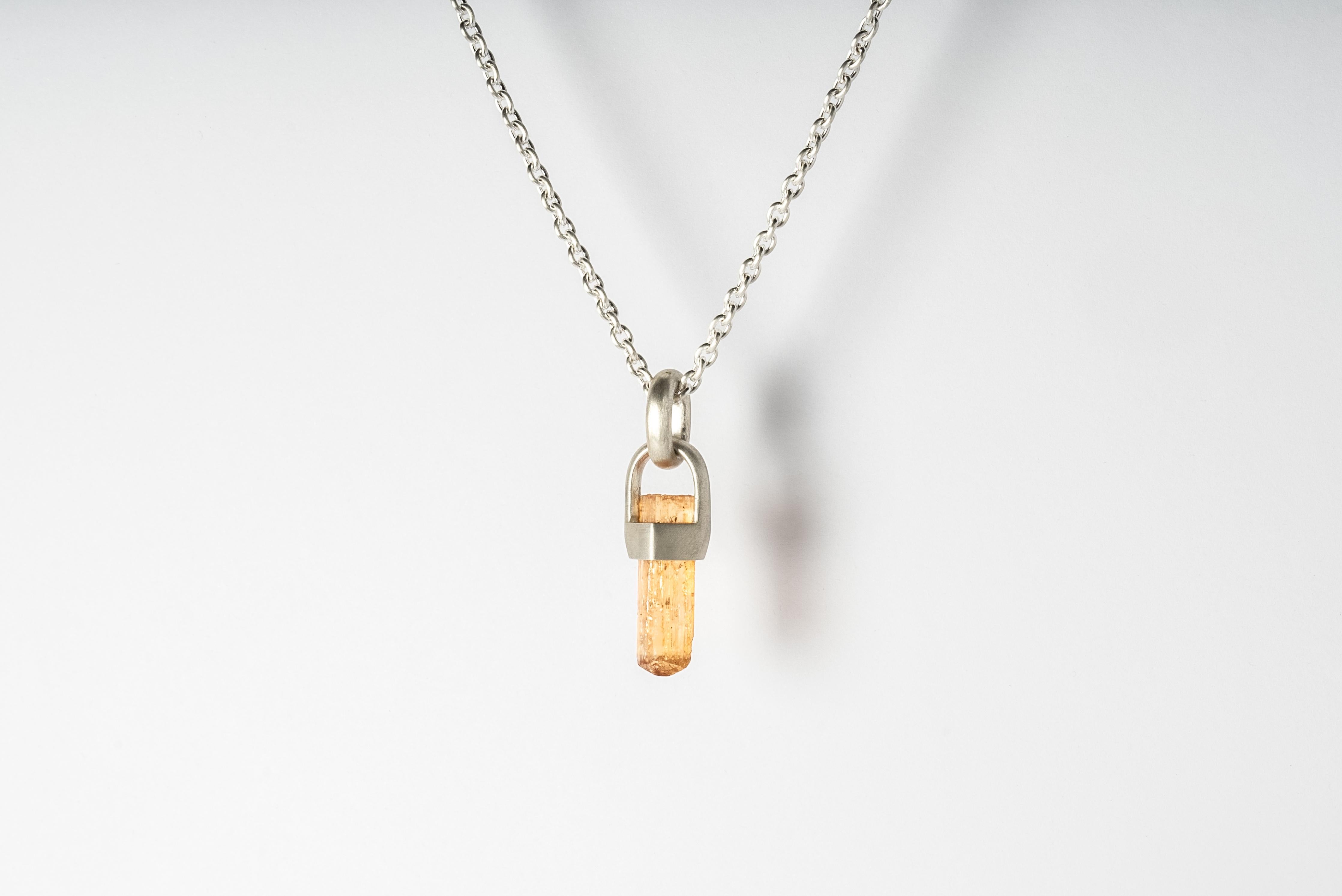 Necklace in matte sterling silver and a rough of imperial topaz. The Talisman series is an exploration into the power of natural crystals. Tools for Magic. The crystals used in these pieces are discovered through adventure and are hand selected.