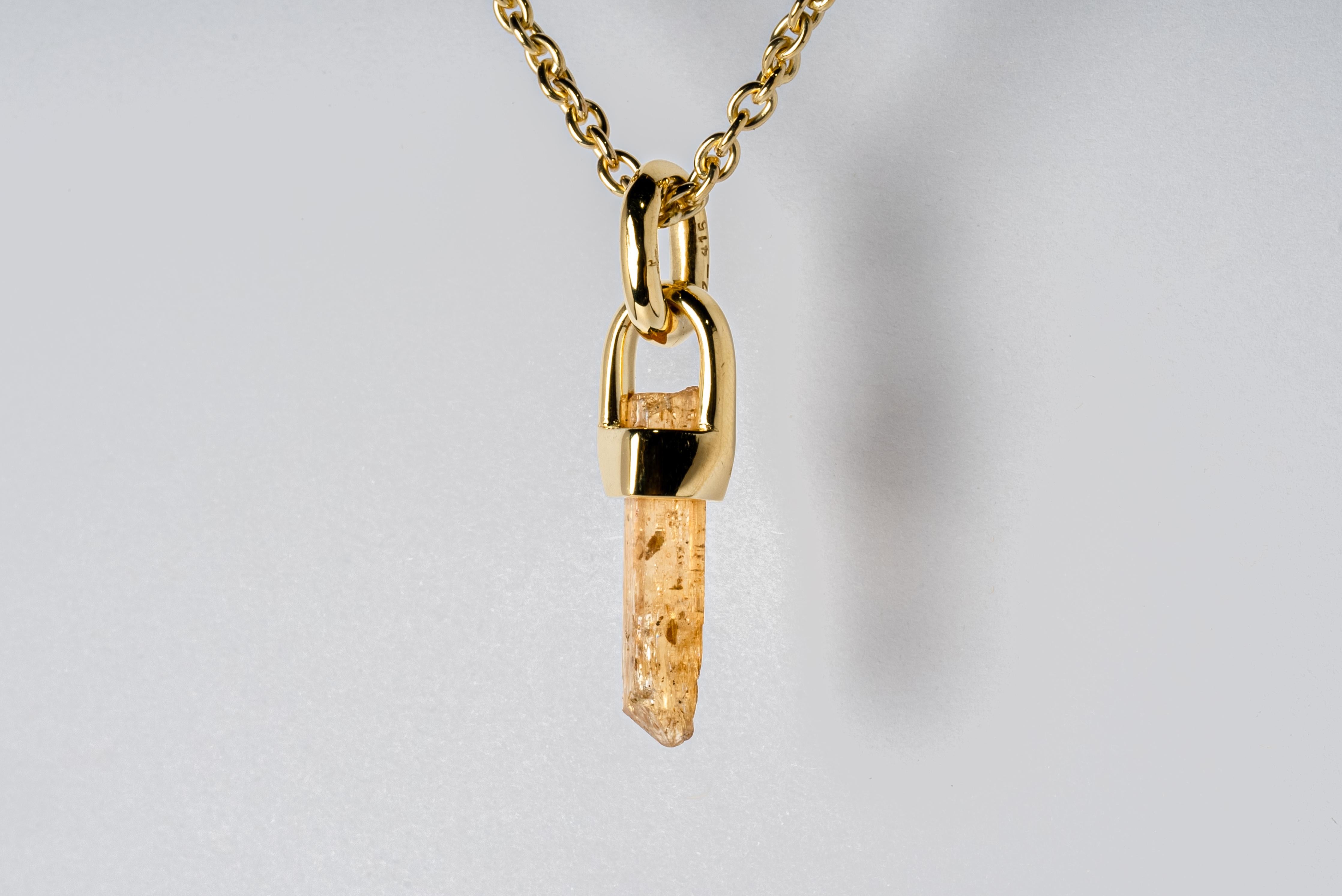 Necklace in brass with 18k gold, sterling silver with 18k gold, and a rough of imperial topaz. The Talisman series is an exploration into the power of natural crystals. Tools for Magic. The crystals used in these pieces are discovered through