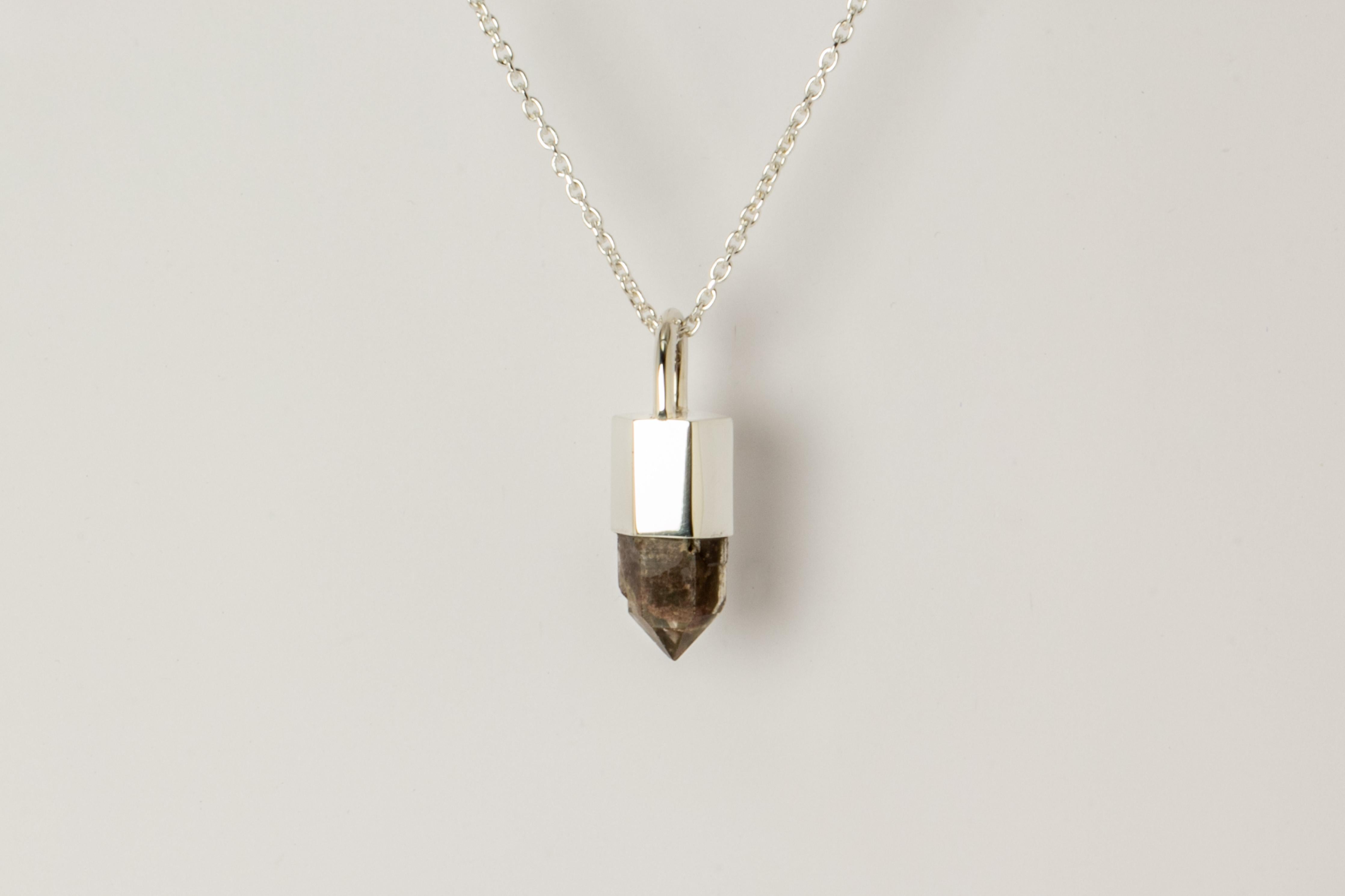 Pendant necklace made in polished sterling silver and a Garden Quartz. It comes on 74 cm sterling silver chain.
The Talisman series is an exploration into the power of natural crystals. The crystals used in these pieces are discovered through